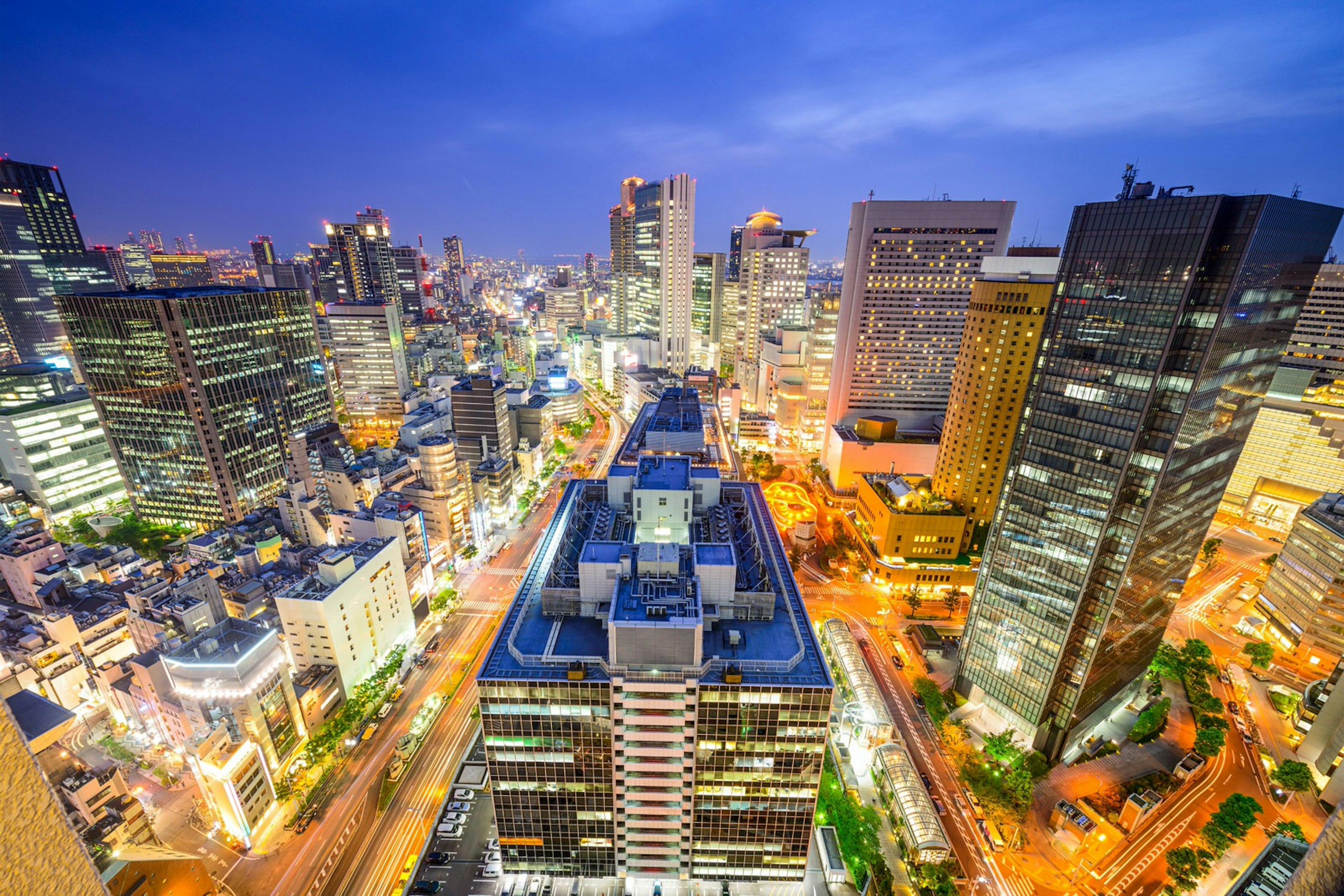 Seen from above Osaka's Umeda District, the city is a maze of bright lights beneath the dark sky