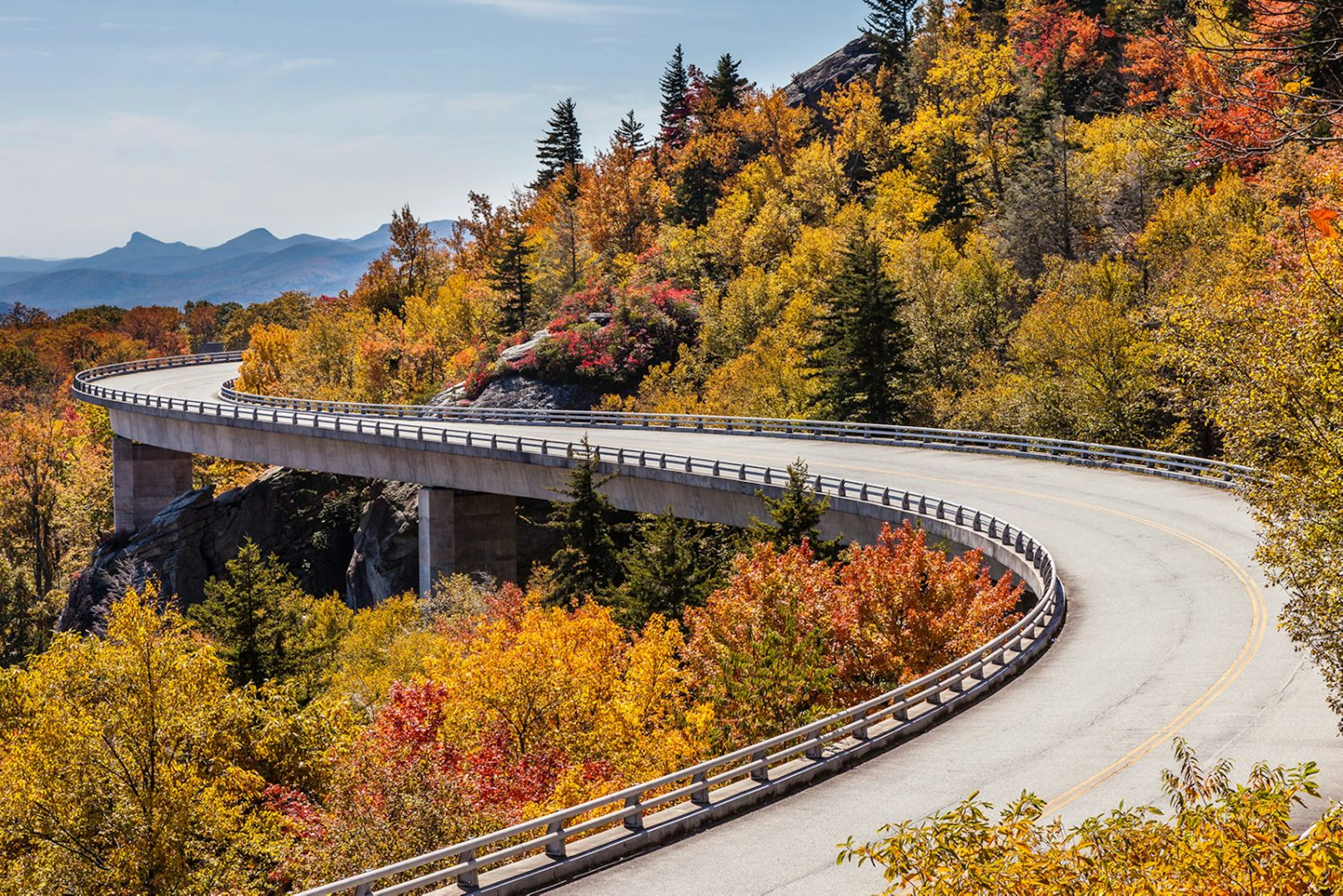 An open road through mountains in the US.