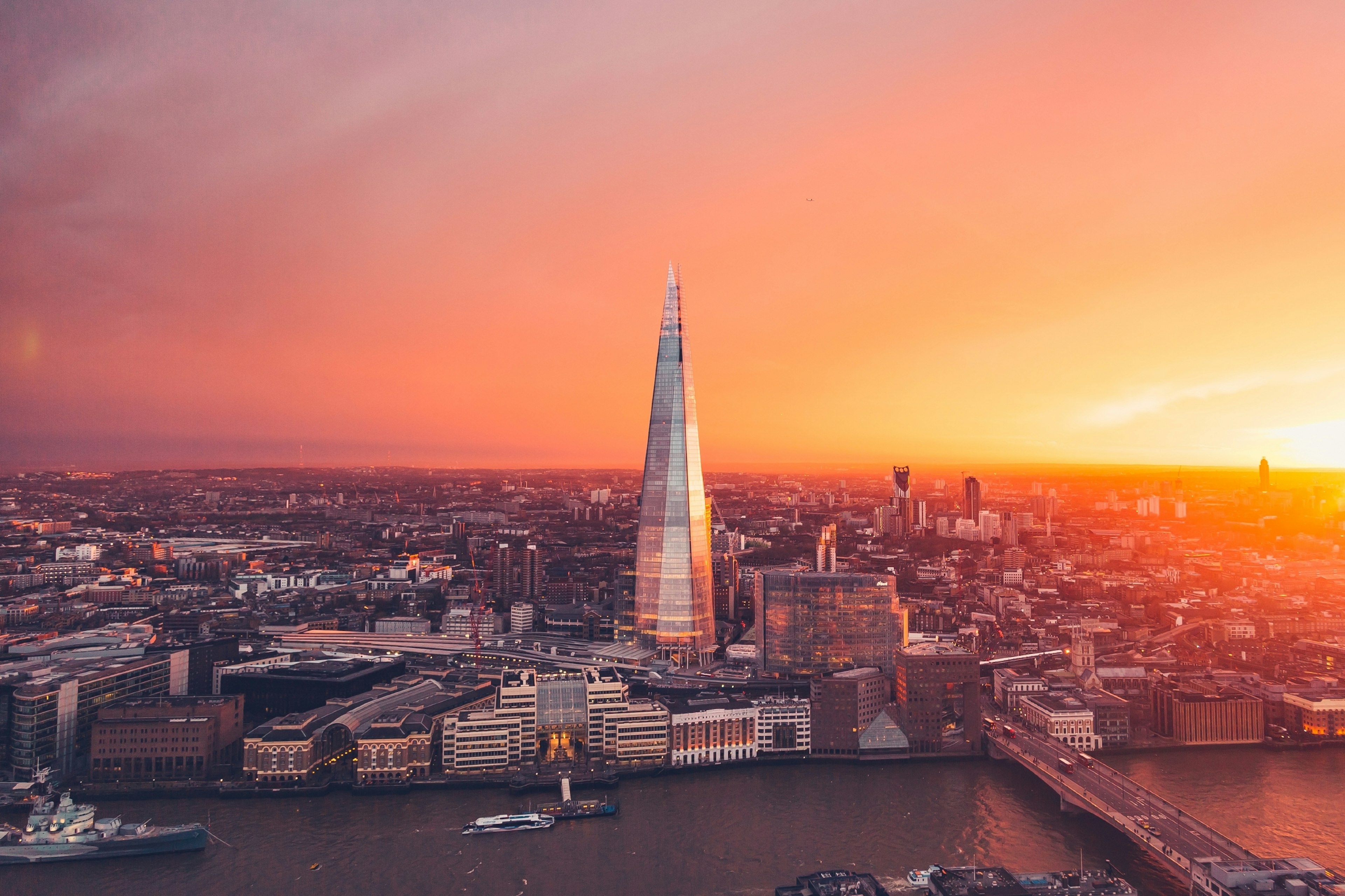 The sun sets behind the Shard in London city.