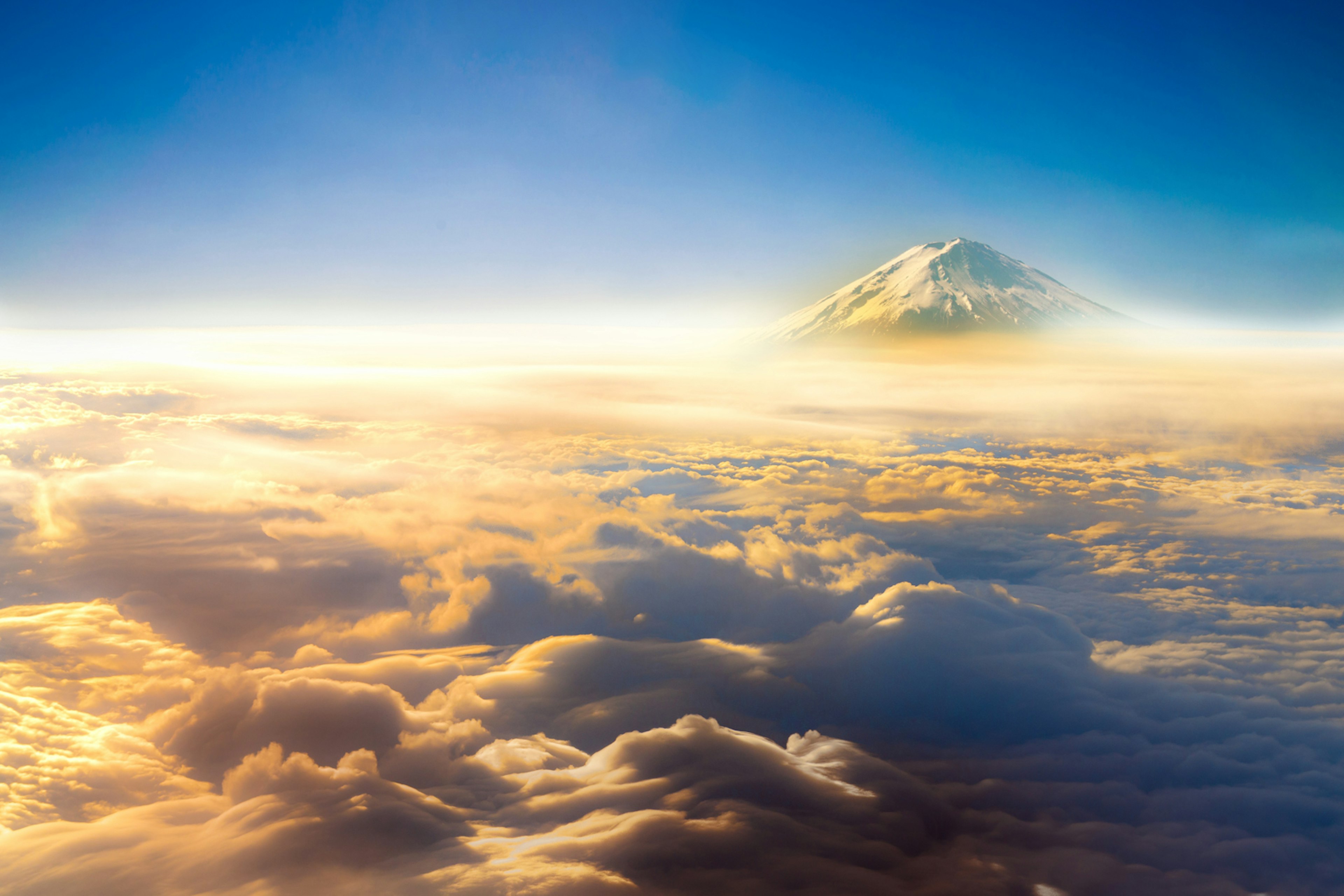 Mount Fuji surrounded by clouds, viewed from above; what causes air turbulence