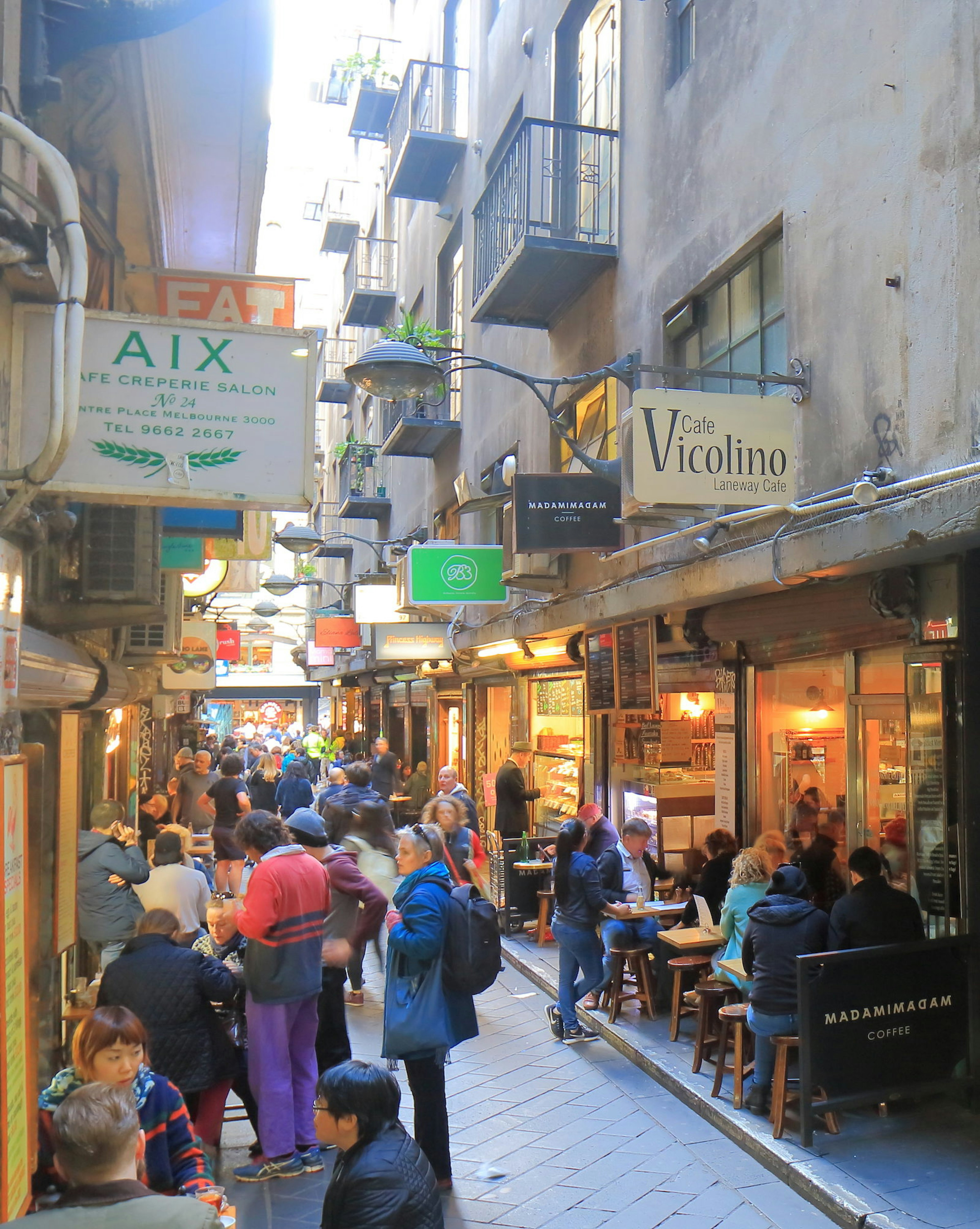 Unidentified people visit Center place cafe street.