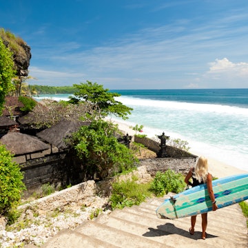 A surfer stands on a staircase leading to the beach and surveys the swell, in Bali.
94532368
sea, sand, bali, surf, coast, shore, beach, woman, sport, surfer, temple, nature, action, outdoor, surfing, athlete, seashore, adventure, indonesia, shoreline, surfboard, coastline, recreation, recreational, surfboarding