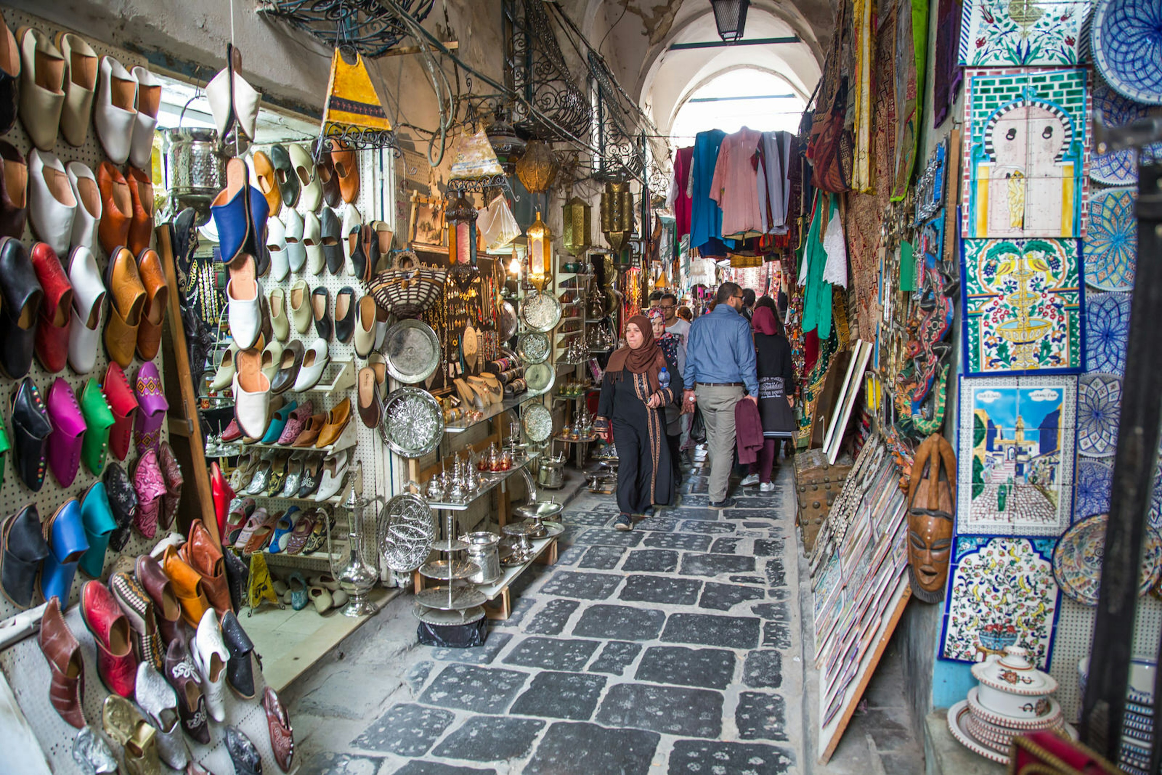 Alleyway through the medina of Tunis, with shops lining both sides of the narrow passageway, Tunisia