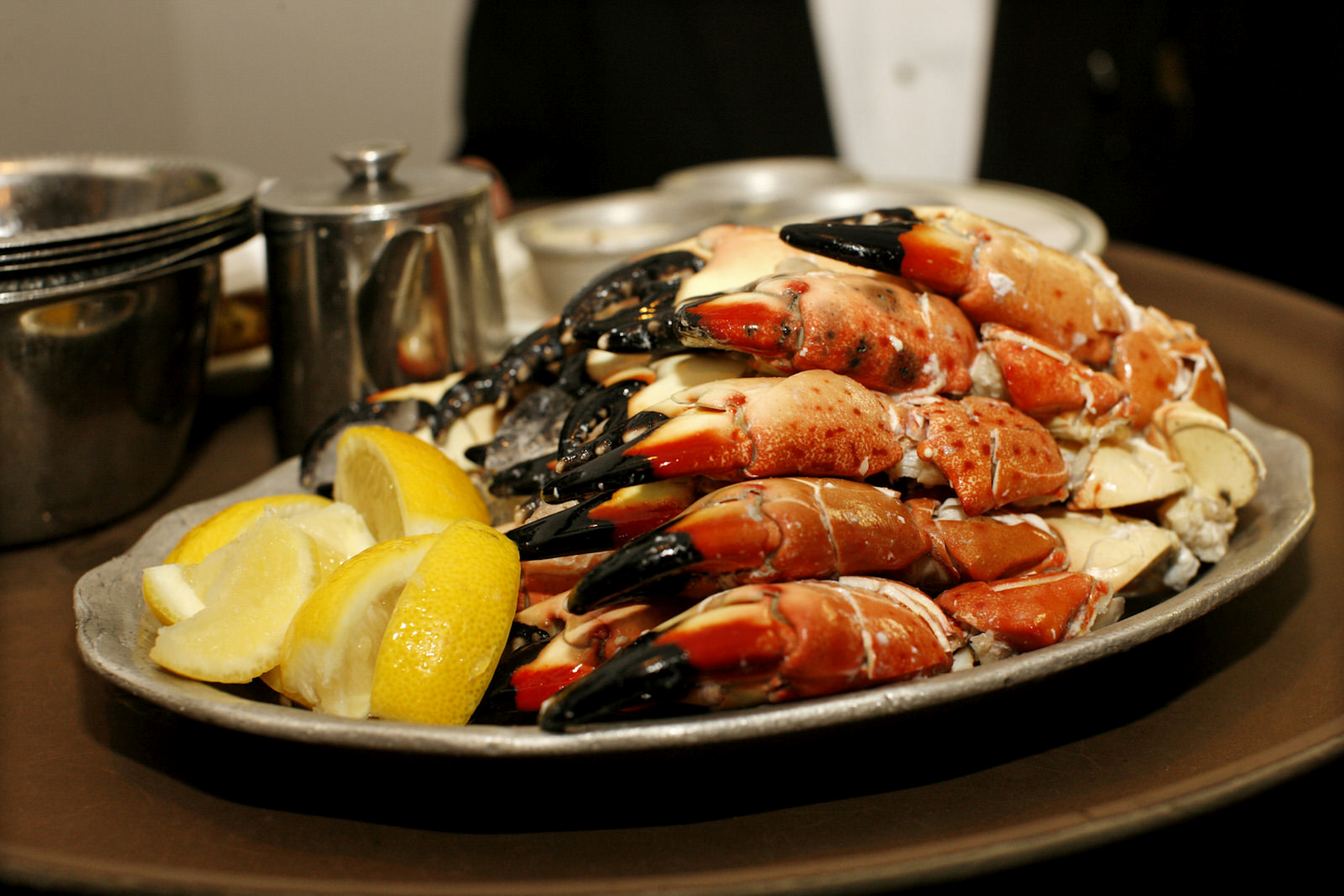 A plate of stone crab legs with lemon slices