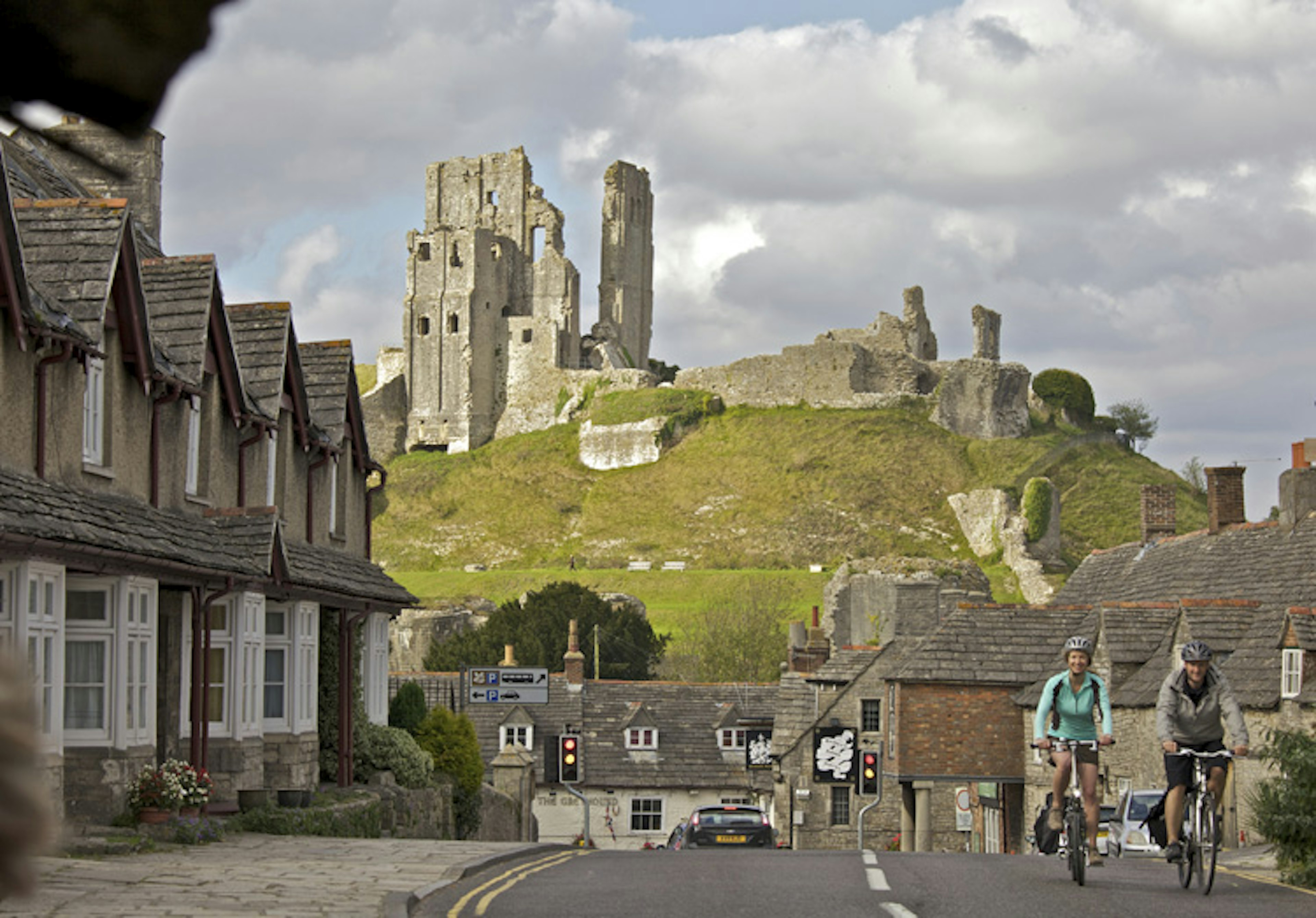 Corfe Castle: Does it get any more romantic than cycling through an English coastal town with a castle in the background? Image courtesy of VisitEngland/Weymouth and Portland Borough Council/Cycle West- Tim Pestridge.  Read more: http://kmwppi.expressfac.com.br/travel-blog/tip-article/?p=71186#ixzz34uARokeG