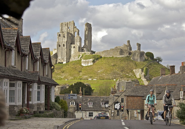 Corfe Castle: Does it get any more romantic than cycling through an English coastal town with a castle in the background? Image courtesy of VisitEngland/Weymouth and Portland Borough Council/Cycle West- Tim Pestridge. Read more: http://www.lonelyplanet.com/travel-blog/tip-article/?p=71186#ixzz34uARokeG