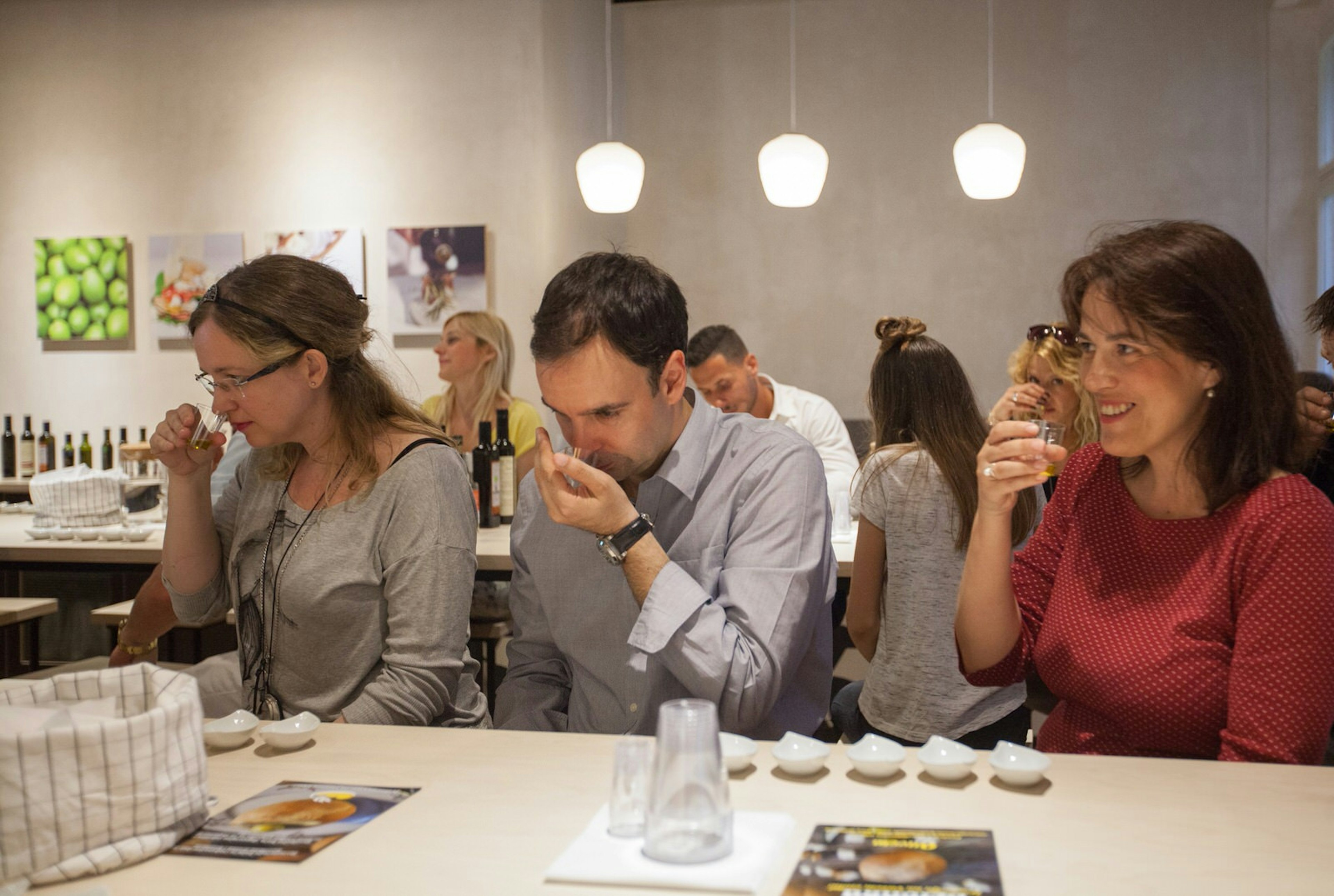 Visitors to the House of Istrian Olive Oil sniff and taste small cups of oil