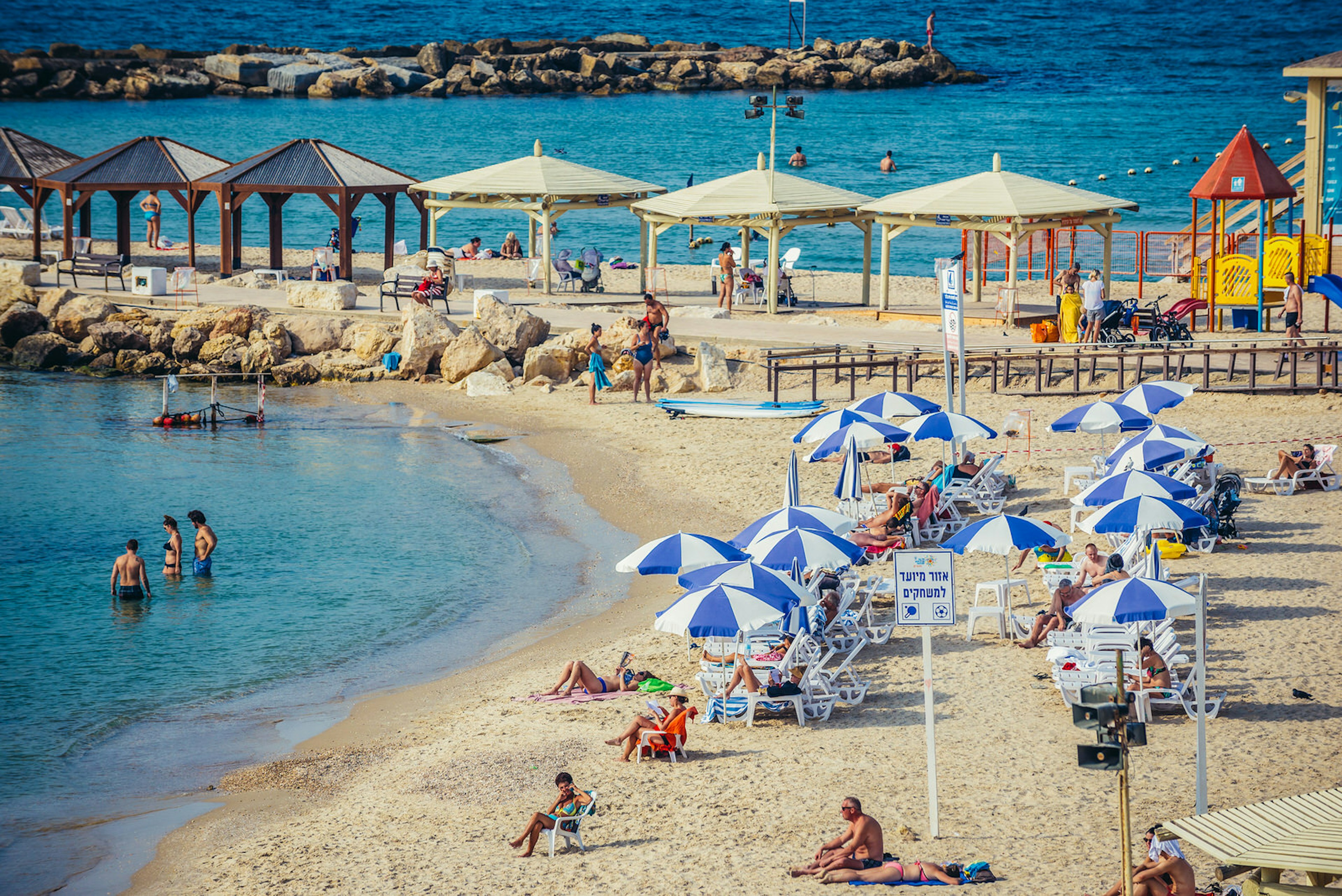 Sunbathers at Hilton Beach, Tel Aviv. Image by Fotokon / Shutterstock