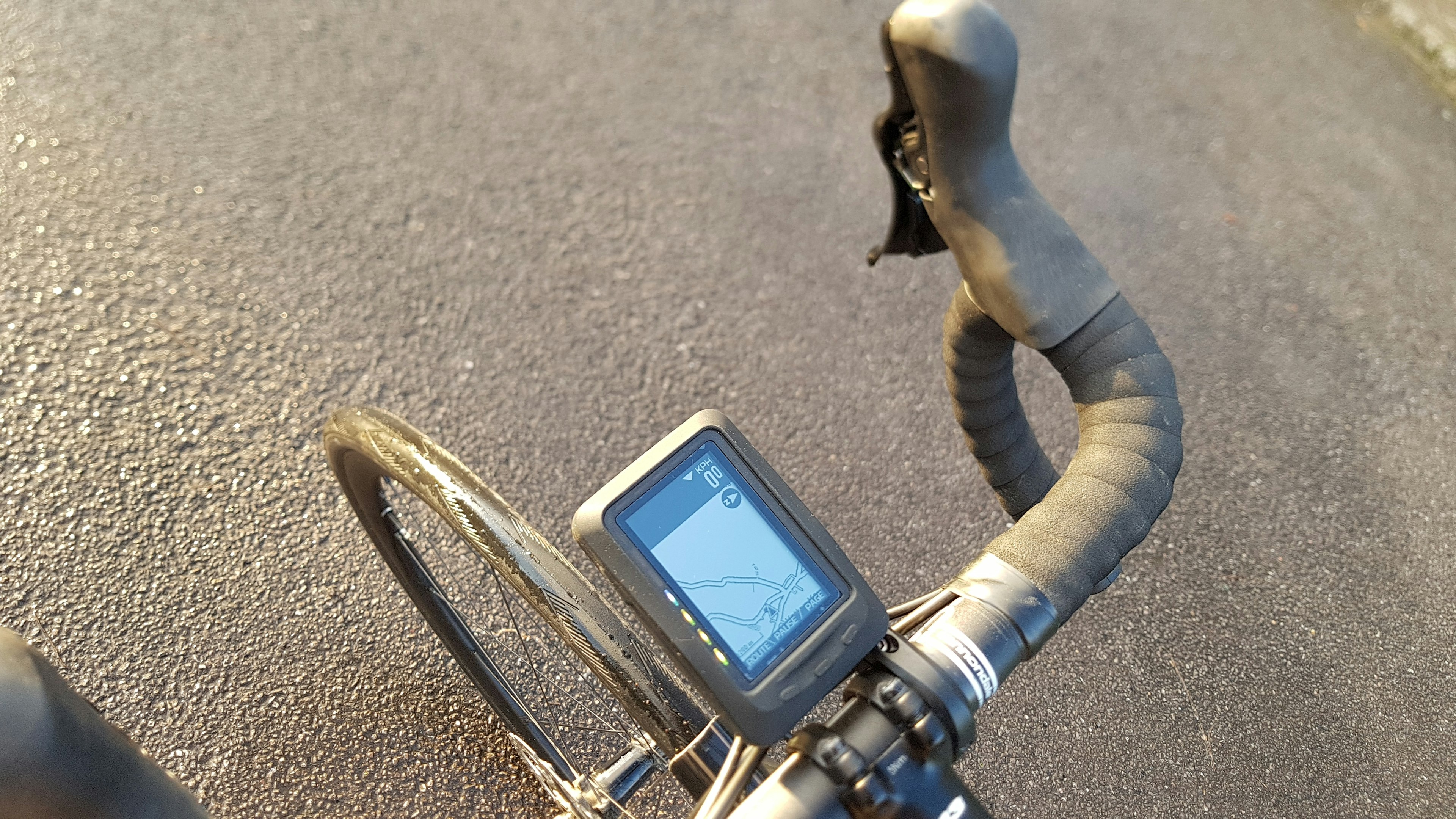 A bike navigation display attached to bike handlebars