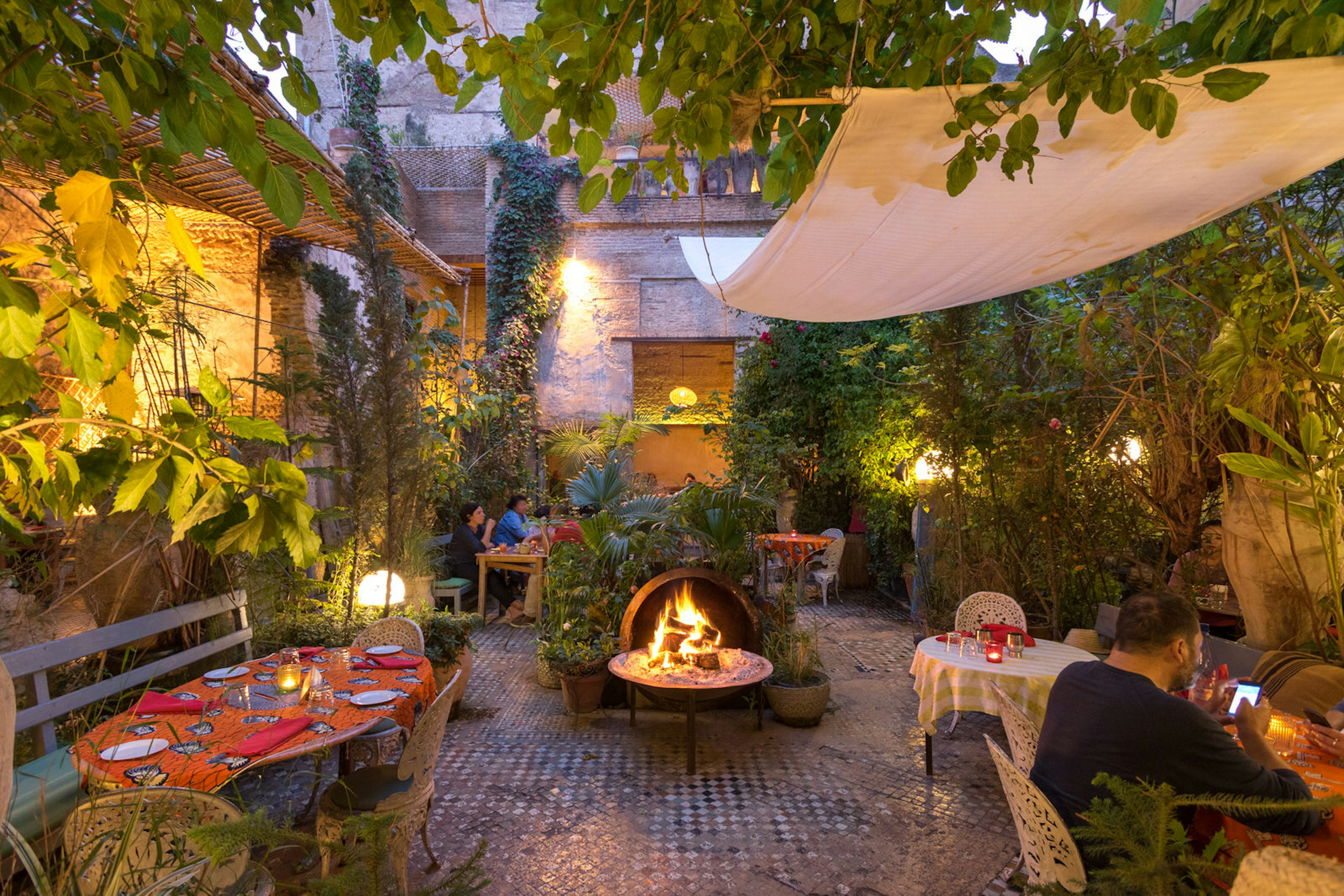 Outdoor garden dining area at The Ruined Garden in Fez. Image by The Ruined Garden