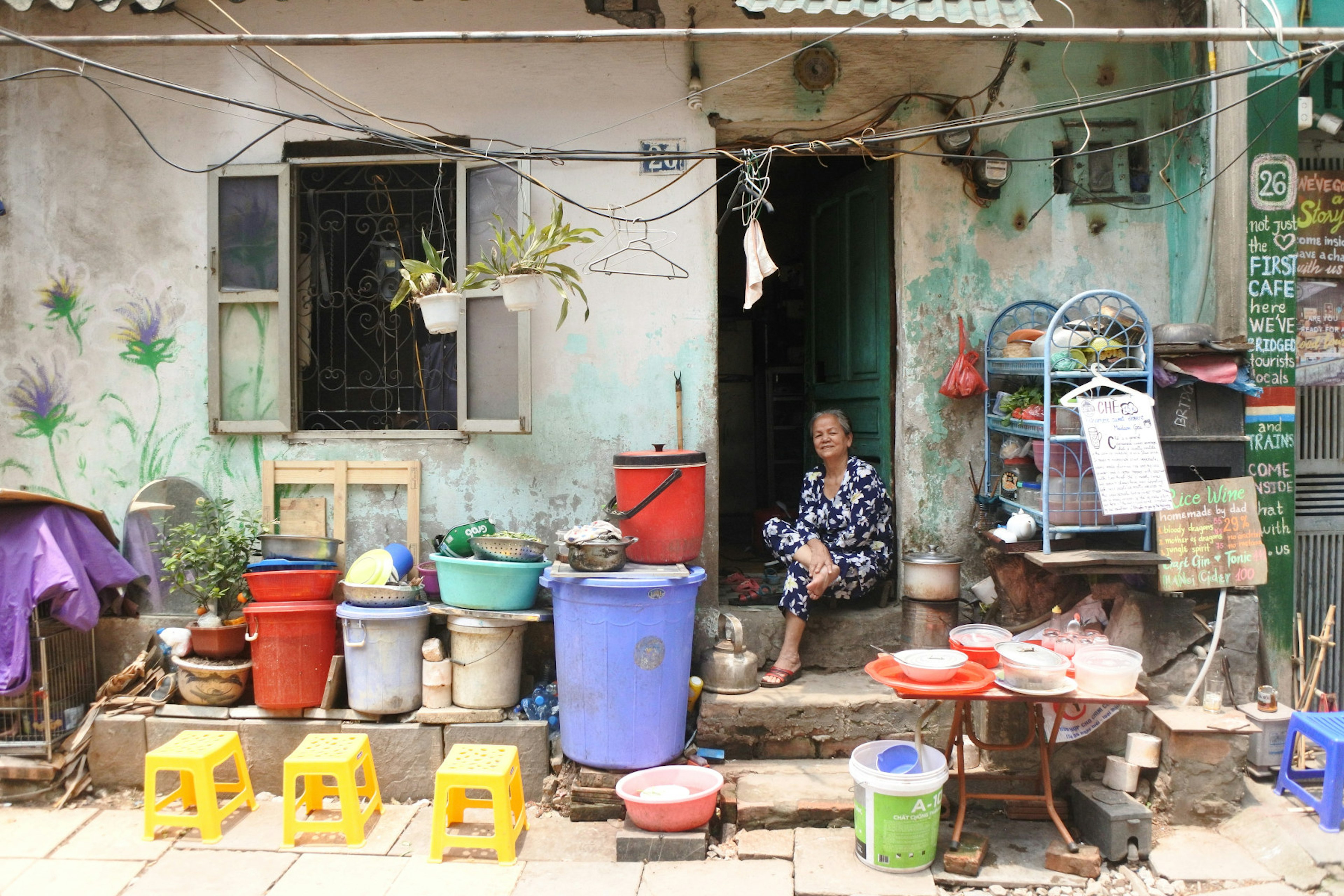 An older woman sitting at an open door.