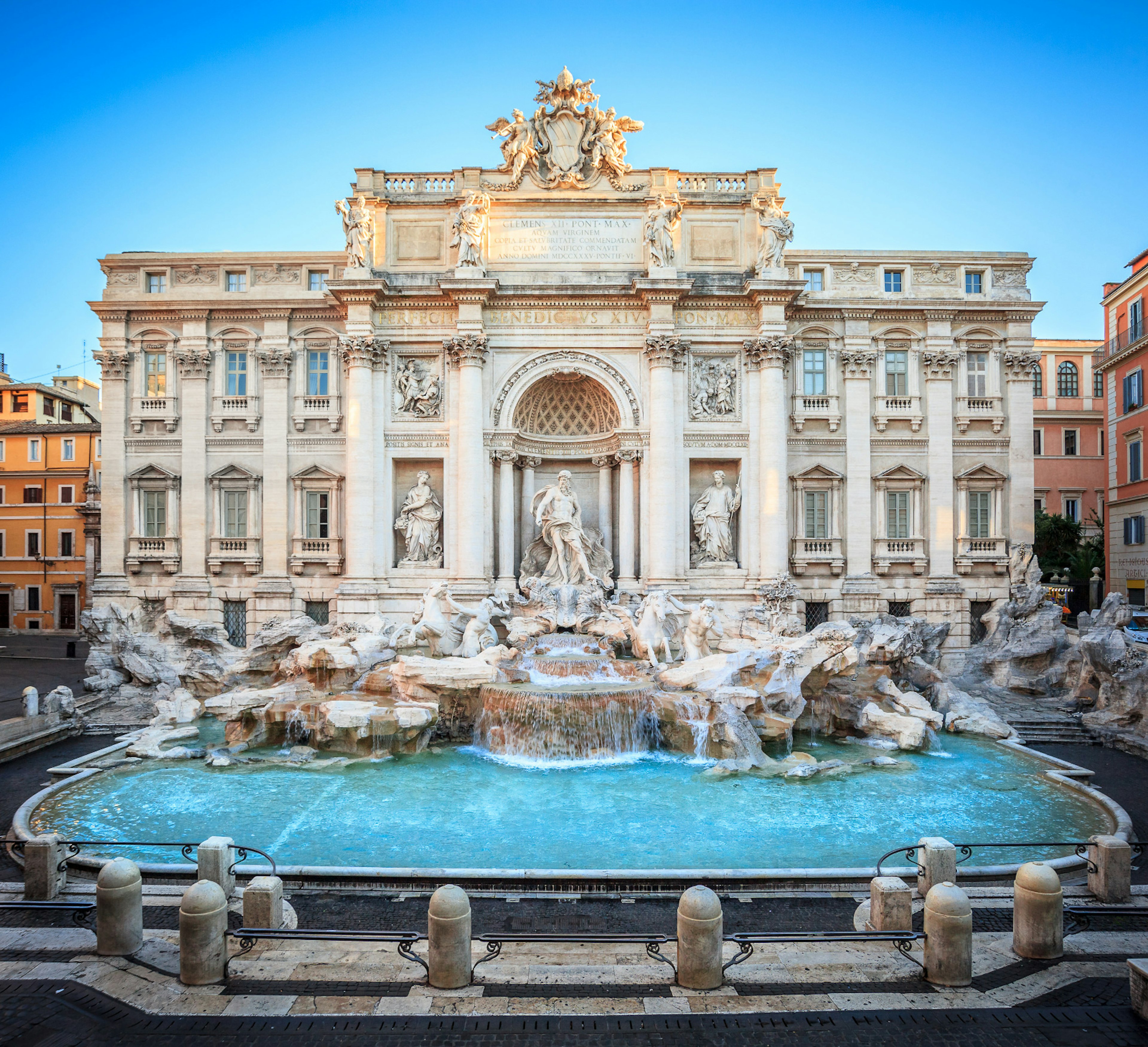 The blue waters of Trevi Fountain are backed by the grandiose Baroque sculptures and mansion-like facade