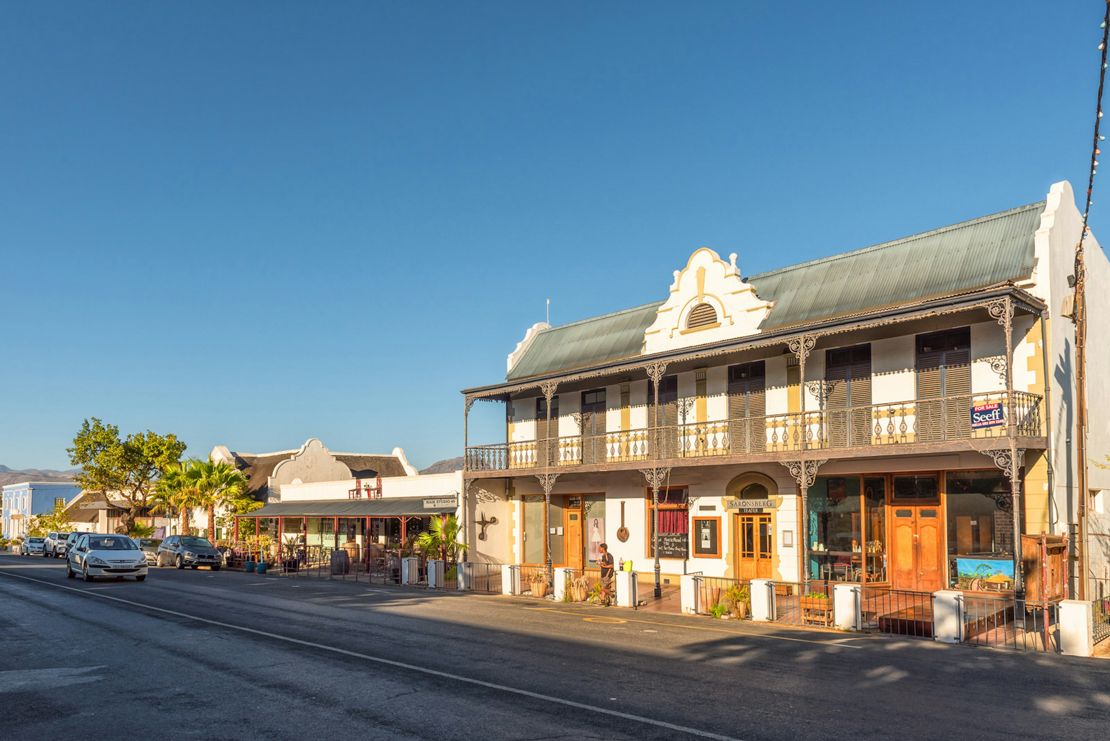 A street lined with historic buildings in the Winelands town of Tulbagh; the main building features covered verandahs on both the ground and first floor