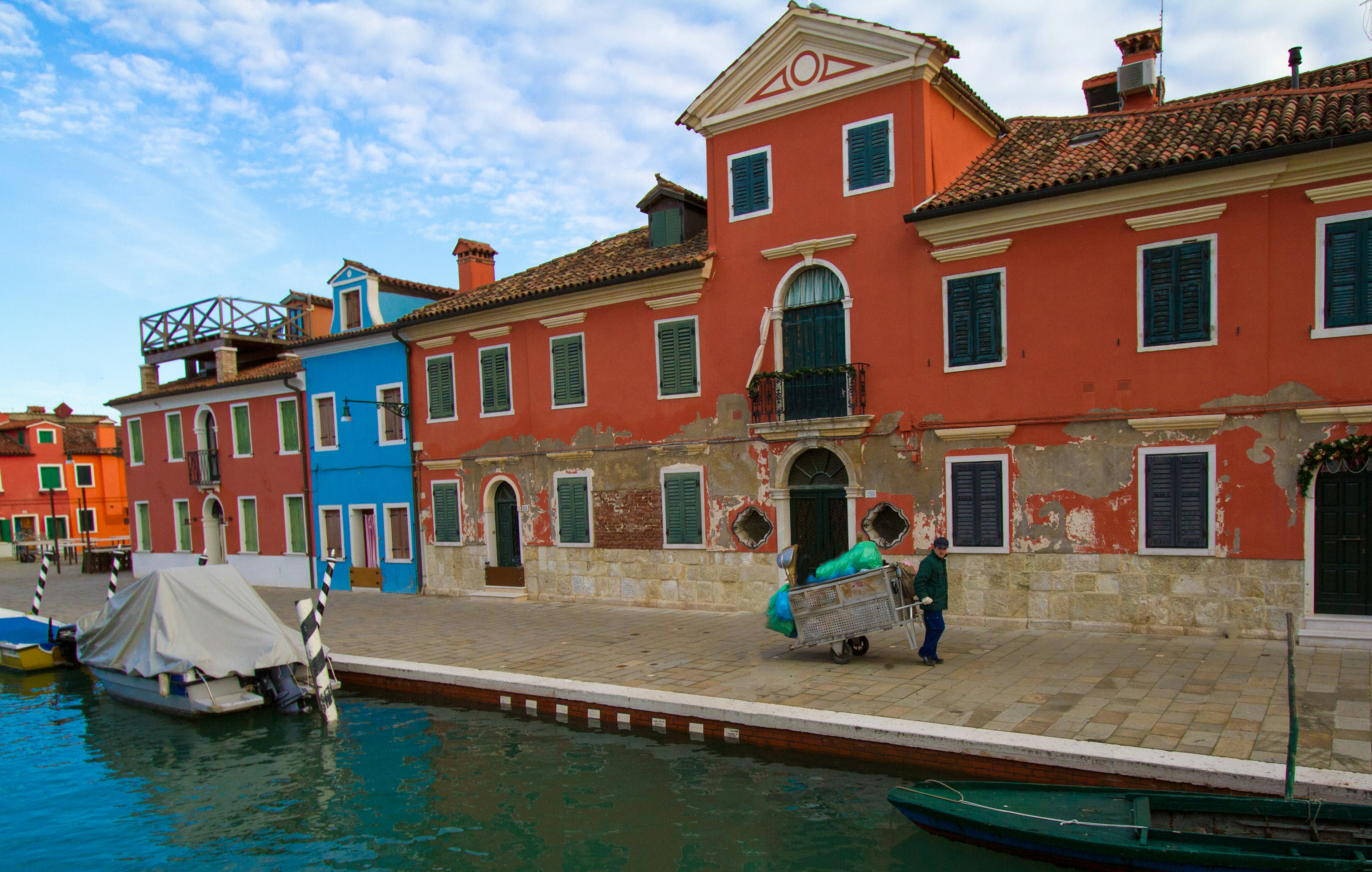 Burano, Italy - December 31, 2013: Hand-drawn carts are used for garbage collection in Venice and its outlying islands. The garbage is then wheeled to a garbage barge.
503918019
Action, Adult, Architectural Feature, Architecture, Beauty, Blue, Burano, Canal, Cart, Cleaning, Cloud, Cloudscape, Collection, Famous Place, Garbage, Government, Italy, Land Vehicle, Male, Men, Motion, Nautical Vessel, One Person, Orange, Plastic Bag, Pulling, Red, Sanitation Worker, Service, Sky, Tourism, Travel, Travel Destinations, Venice - Italy, Vibrant Color, Walking, Wheel, Winter, Working