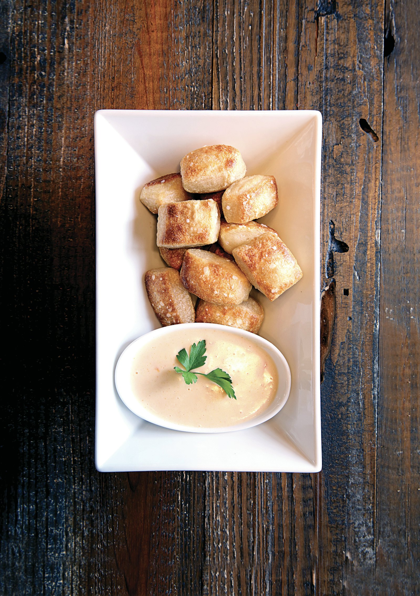 pimento cheese fondue in a white porcelain dish on a rustic barnwood table in Augusta Georgia