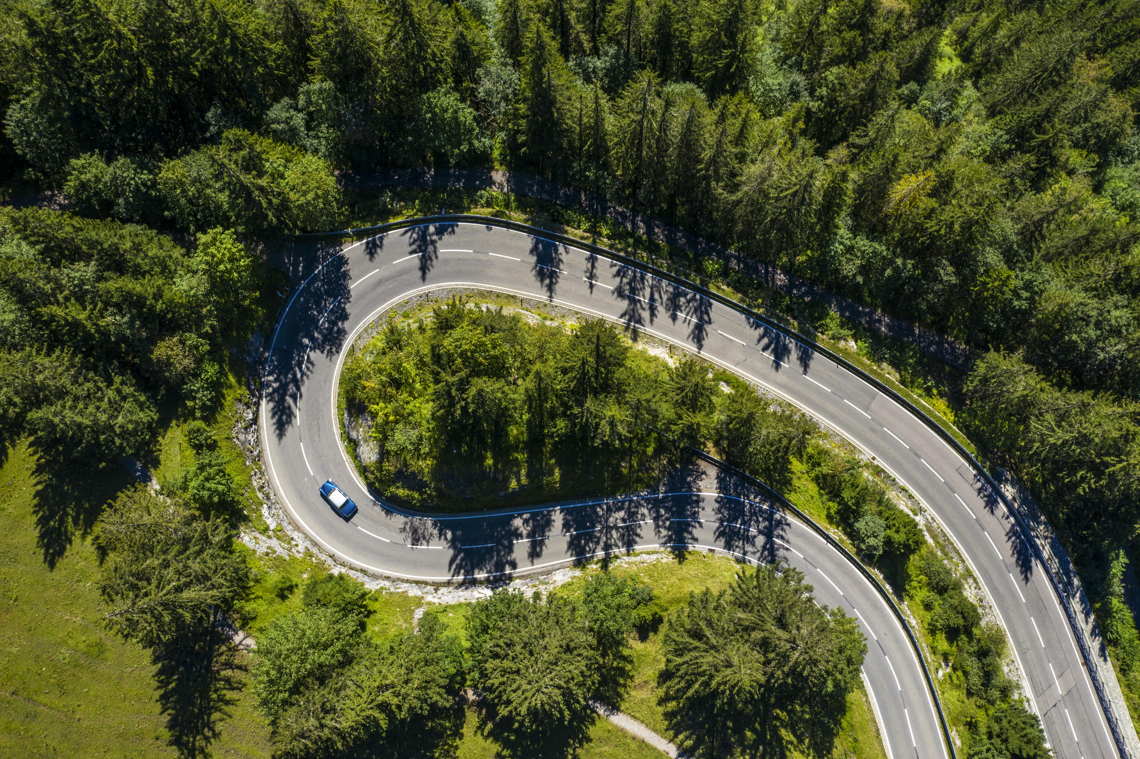 Looking down on a winding road through the Bavarian countryside in Germany with a large switchback