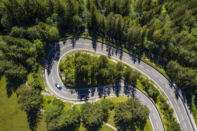 Looking down on a winding road through the Bavarian countryside in Germany with a large switchback
