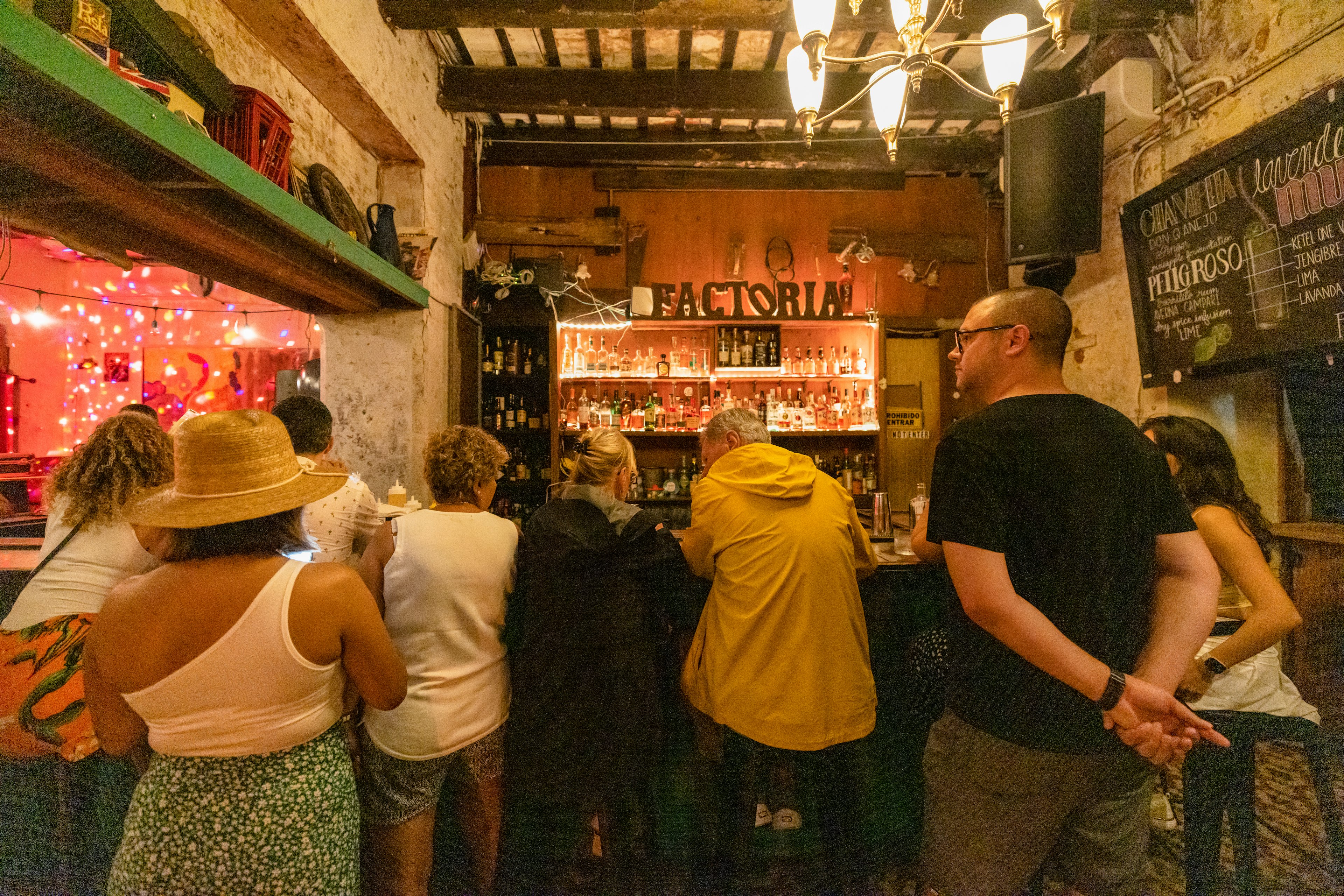 A group of people gathered at the bar in Factoría, San Juan, Puerto Rico