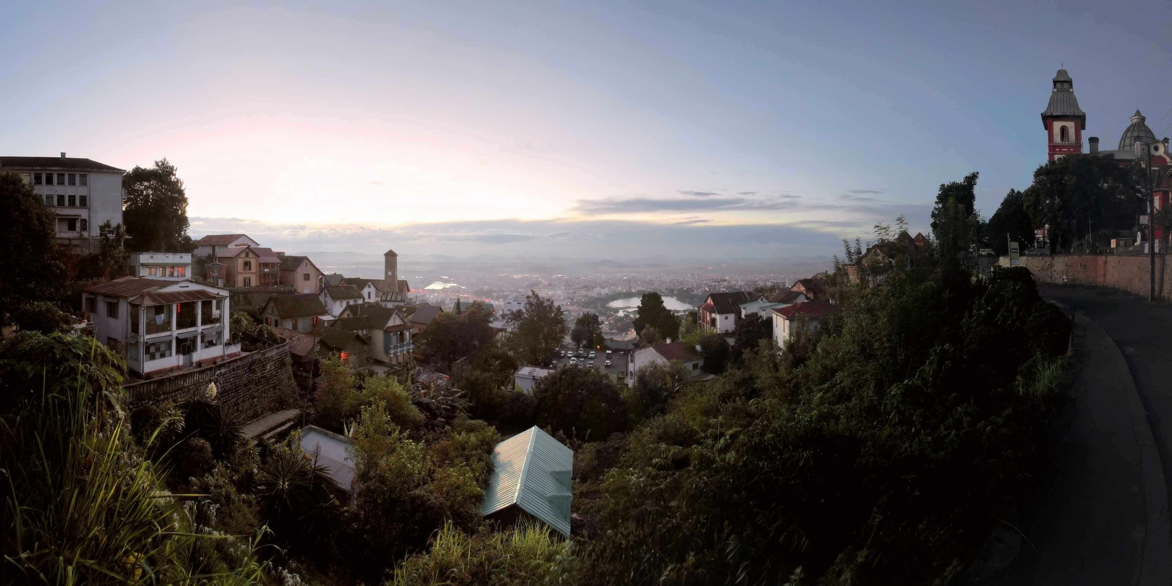 This view looks down a gentle gorge from the top of Antananarivo to Lac Anosy in the distance. On the right ride is the historic tower of the Rova