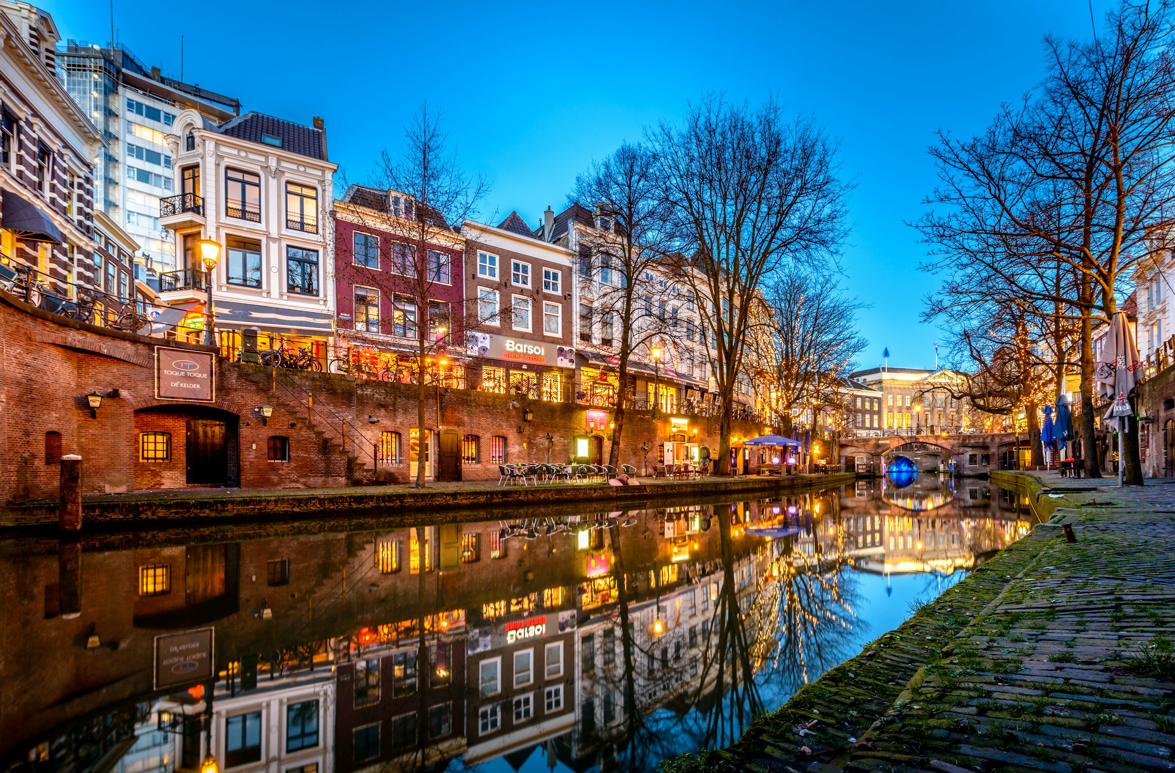 The canalside in Utrecht is lit up at dusk