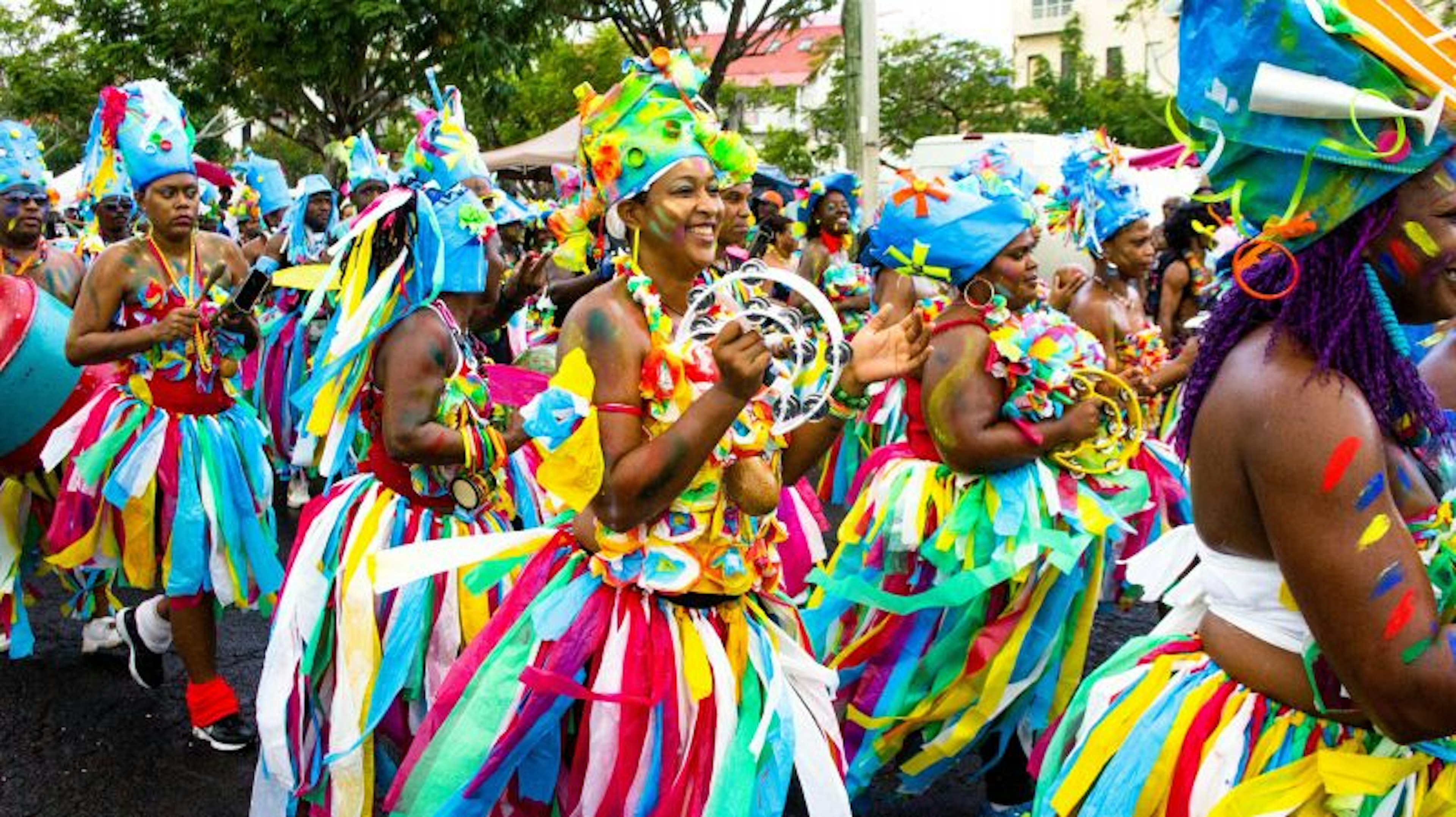 Women in brightly colored costumes participate in a carnival parade in Martinique