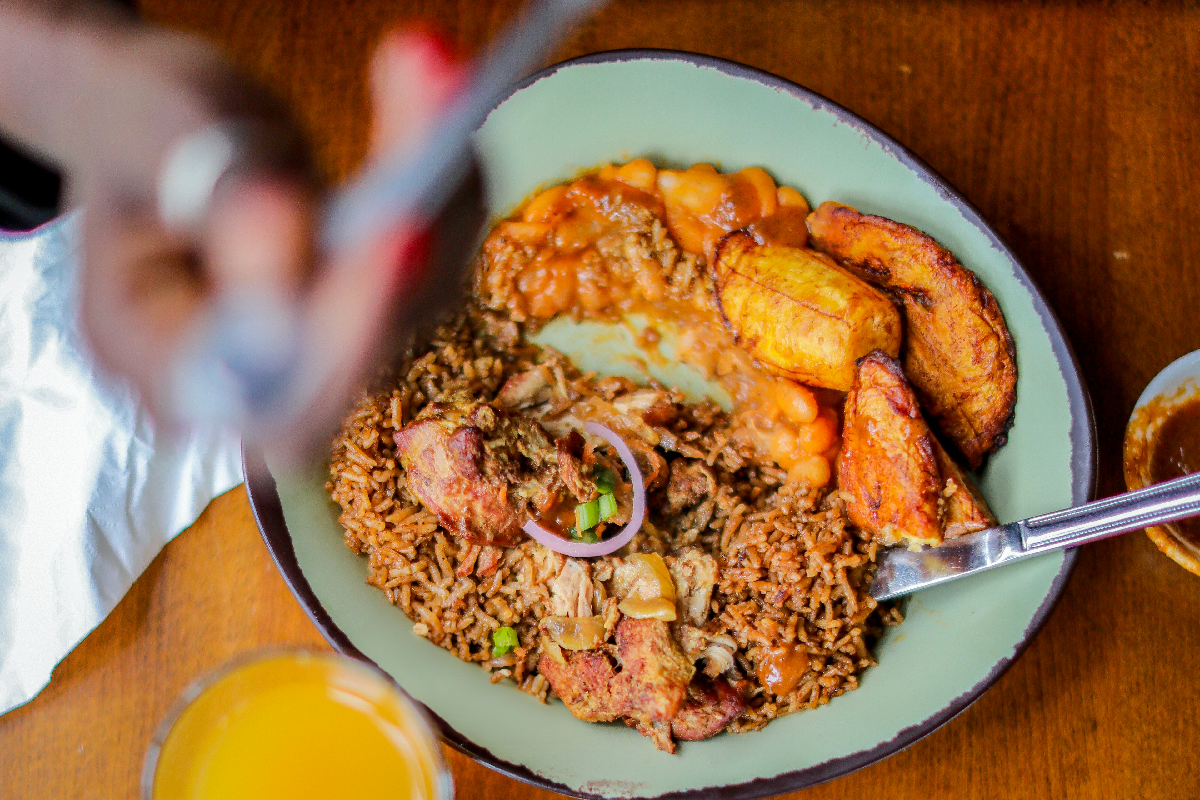 Kuku: pan-fried chicken served in a tangy mustard sauce with soft plantains, earthy yellow beans, and your choice of their spiced rice pilau or coconut rice at Baobab Fare restaurant, Detroit, Michigan, USA