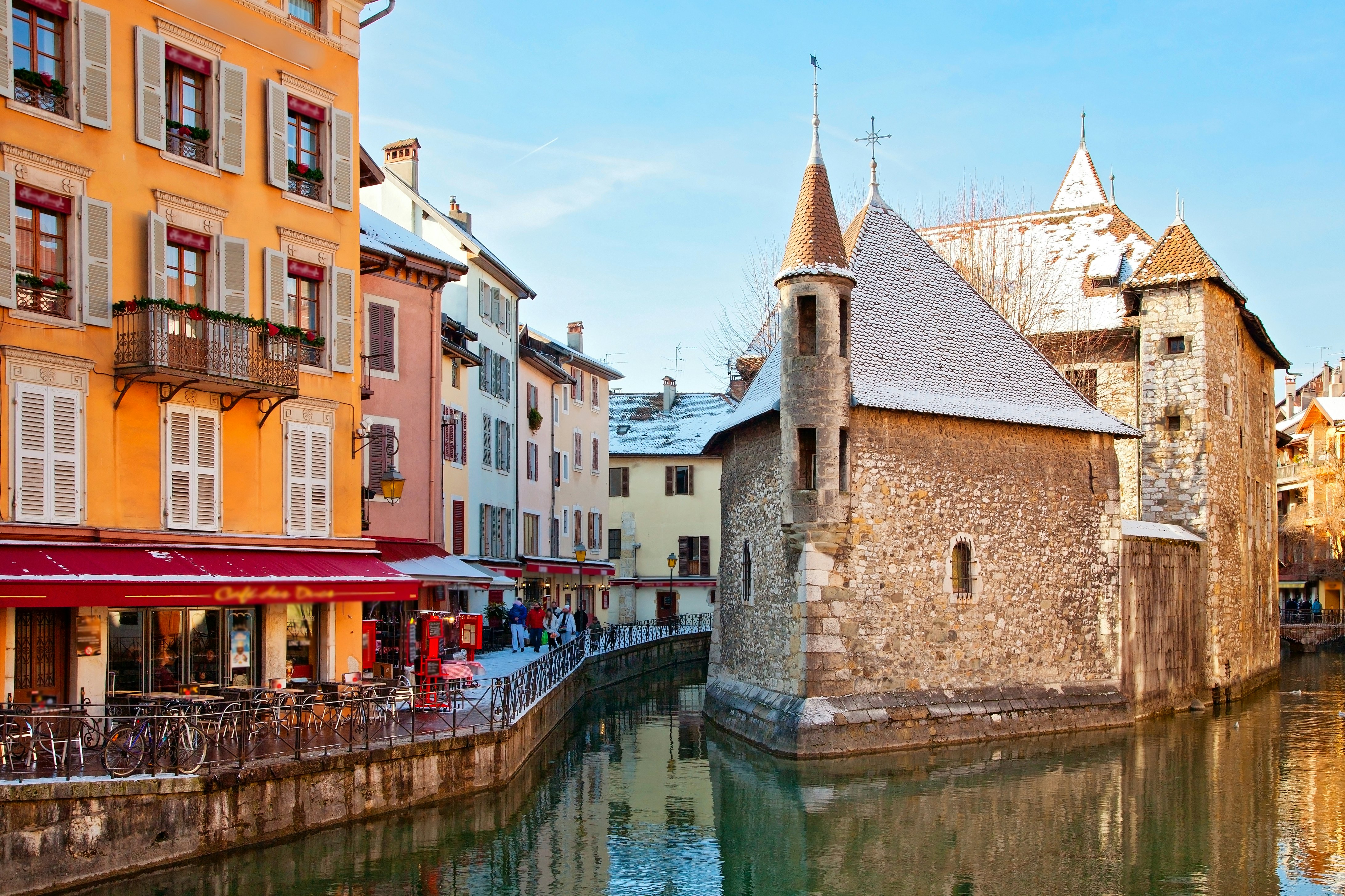 A light dusting of snow covers buildings on the edge of a canal in France's Annecy.