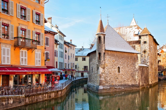 A light dusting of snow covers buildings on the edge of a canal in France's Annecy.