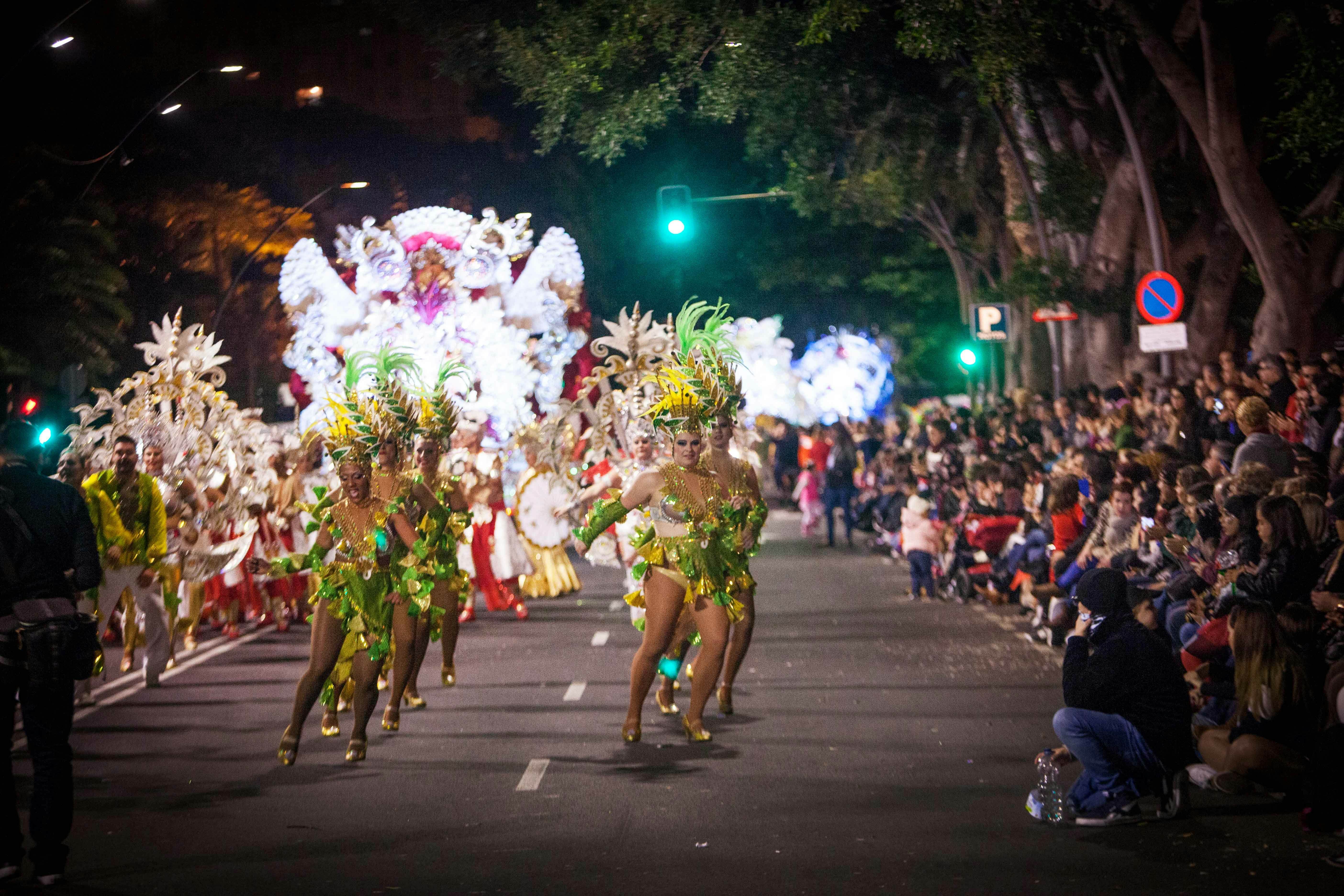 Dancers in sparkly, feathered costumes parade in the street during Carnaval in Santa Cruz, the Spanish Canary island of Tenerife