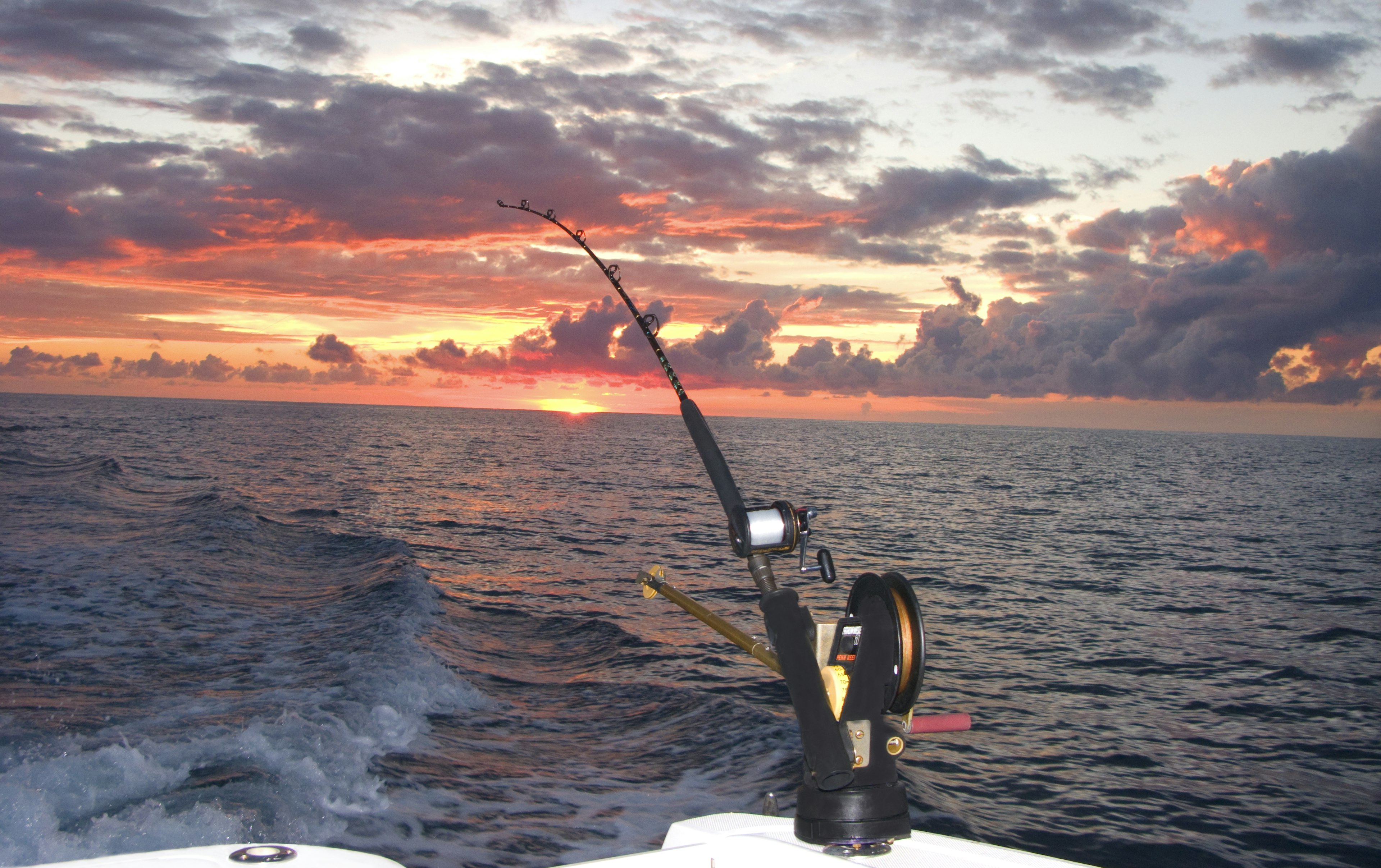 A fishing pole with downrigger trolling at sunset, Bimini, Bahamas