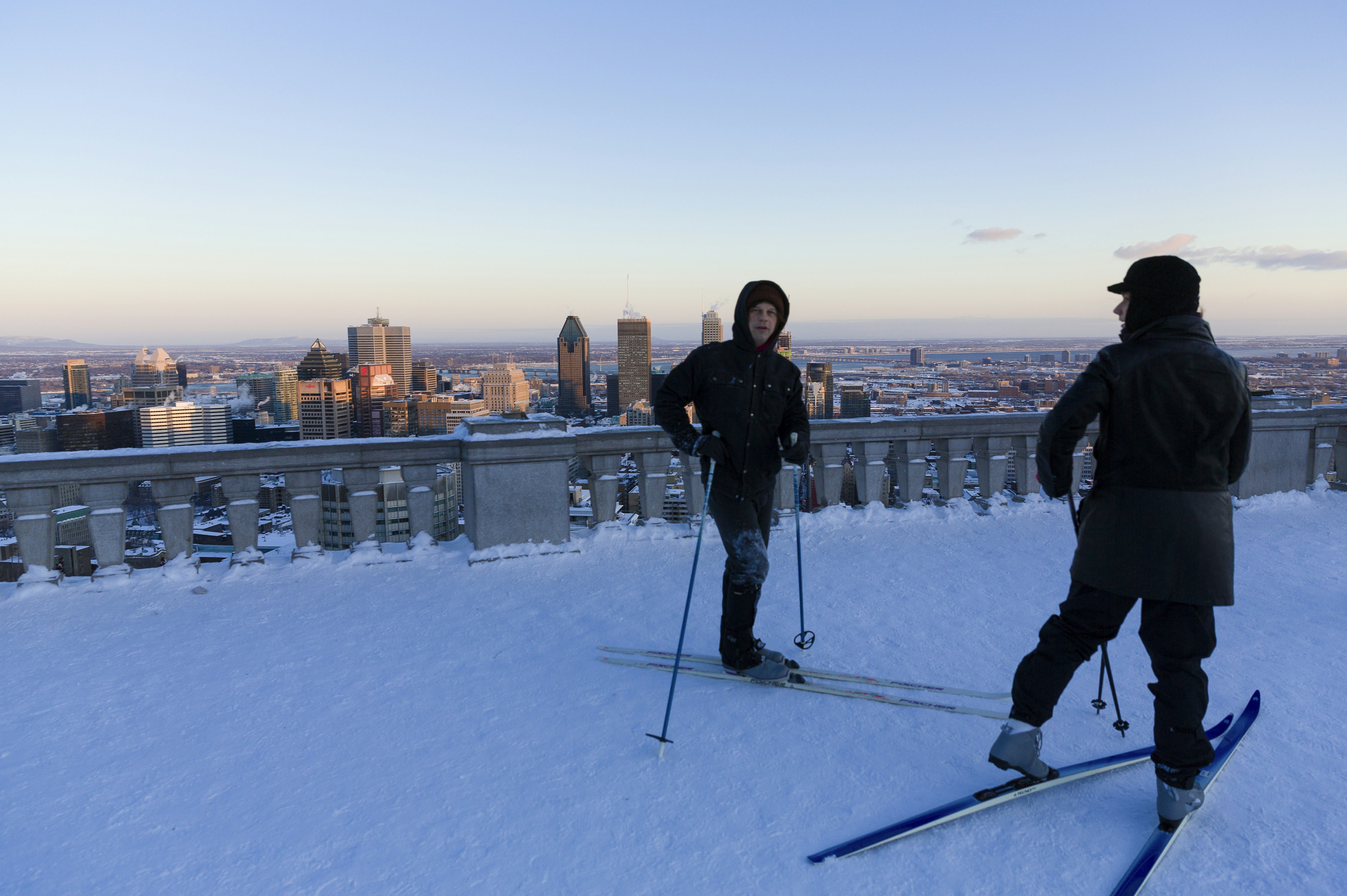 Two cross-country skiiers on the snow at Belvédère Kondiaronk lookout at the top of Mont-Royal, Montréal, Québec, Canada