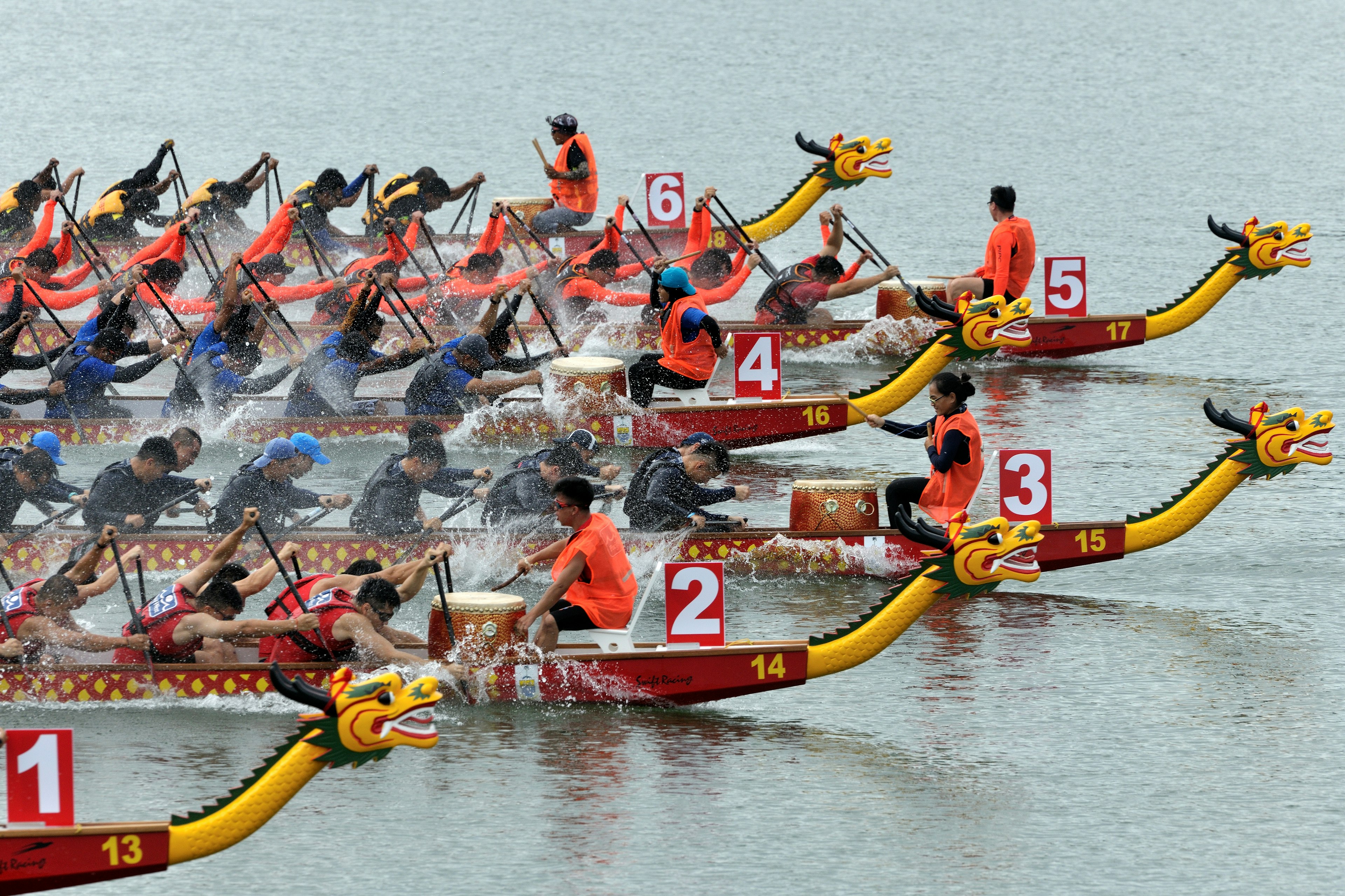 Racers in colorful boats at the Penang International Dragon Boat Festival, Penang, Malaysia