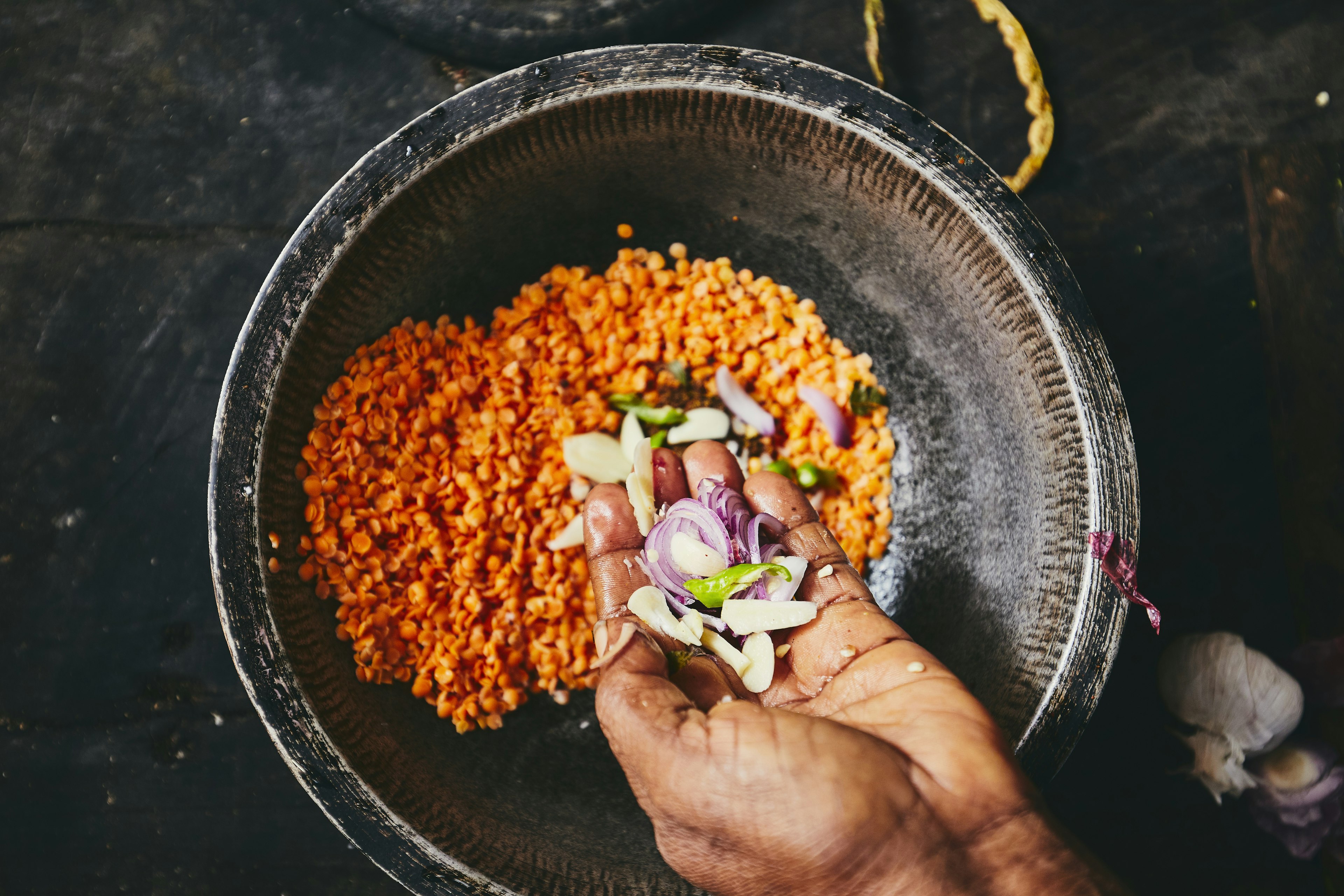 Preparation rice and curry meal. Woman preparing food in traditional home kitchen in Sri Lanka.