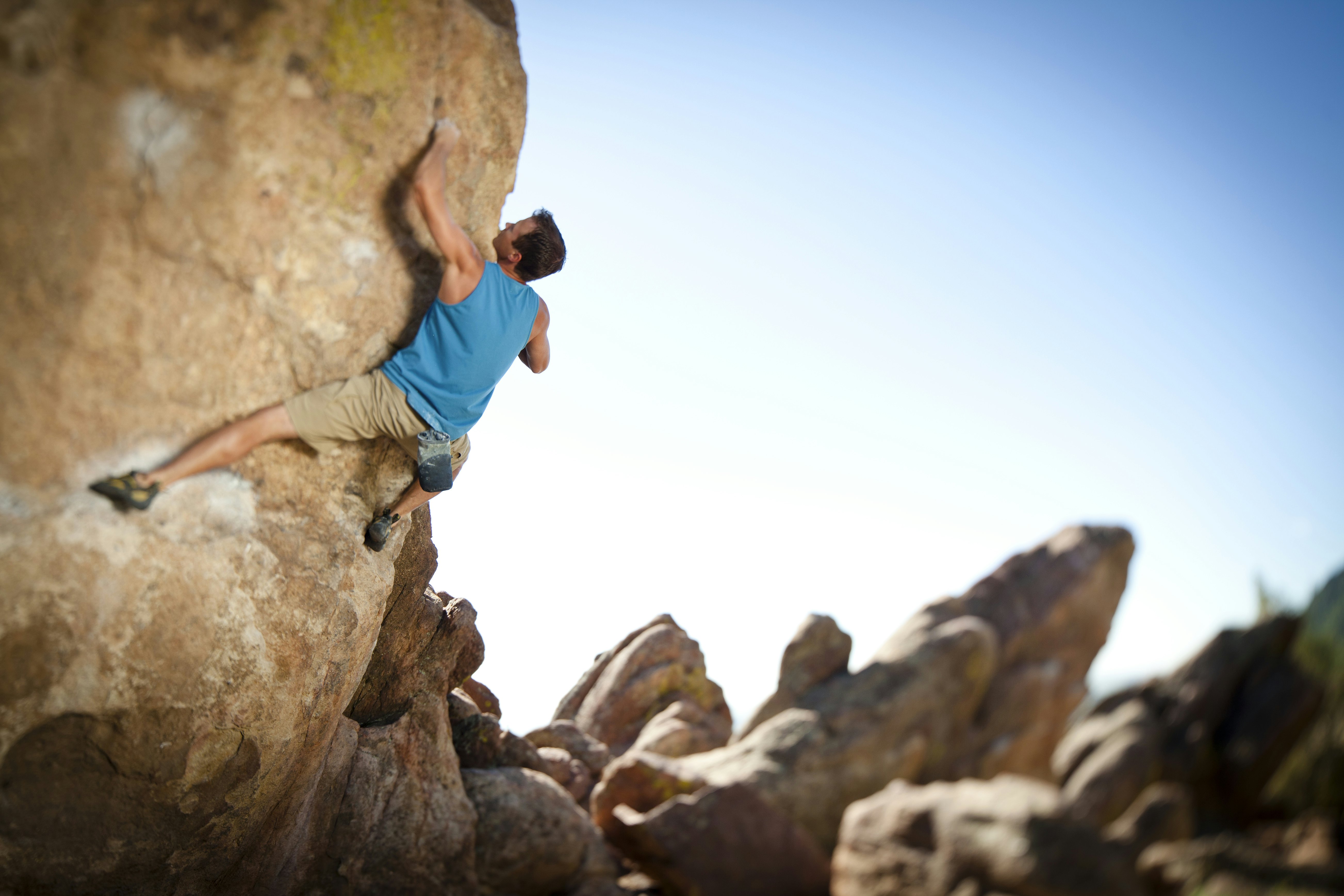 Male rock climber bouldering on Flagstaff Mountain in Boulder, Colorado.