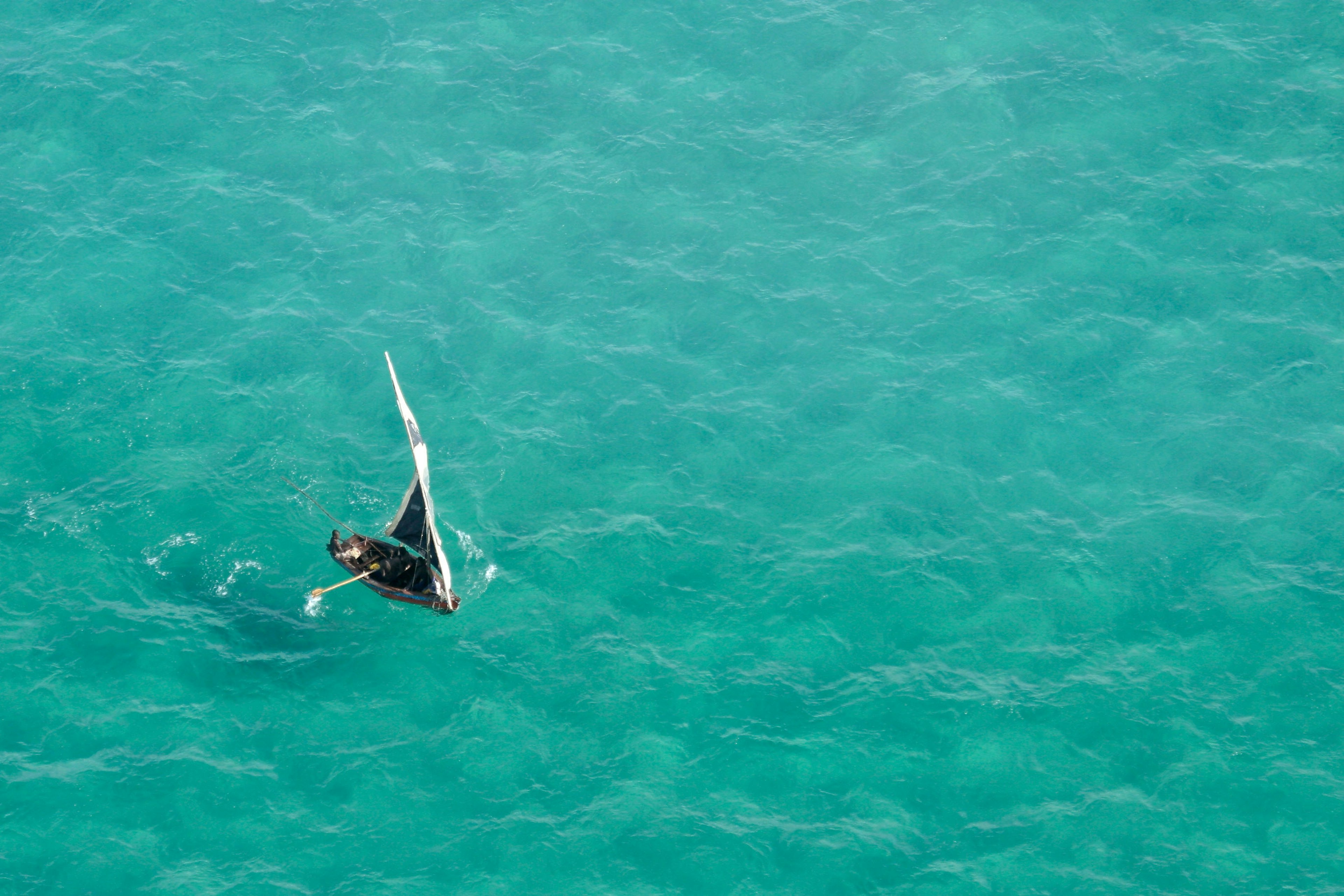 Aerial view of a small sailboat (called a dhow) on the open sea, Mozambique, southern Africa.