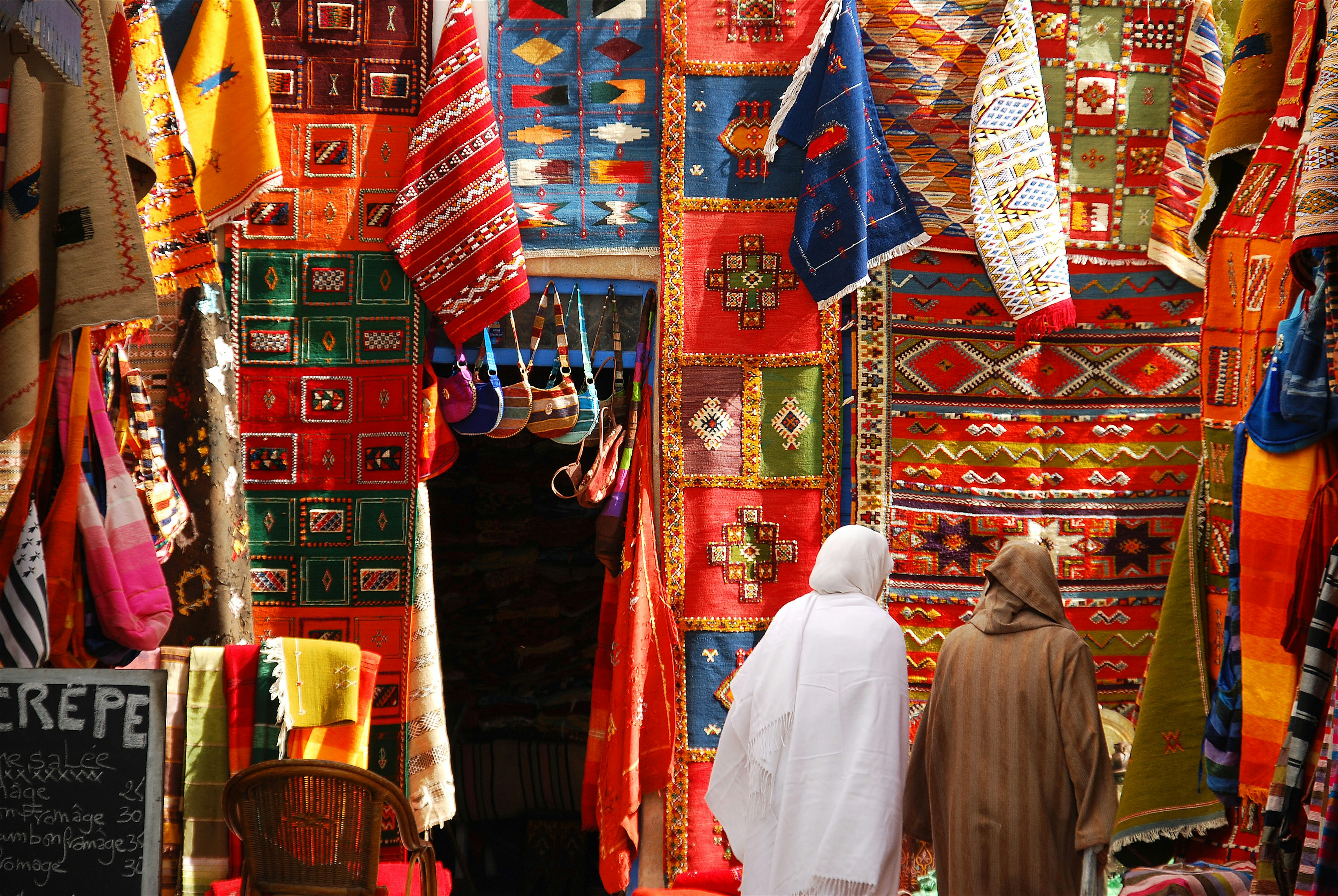 Women wandering through the Carpet Market in Essaouira, Morocco