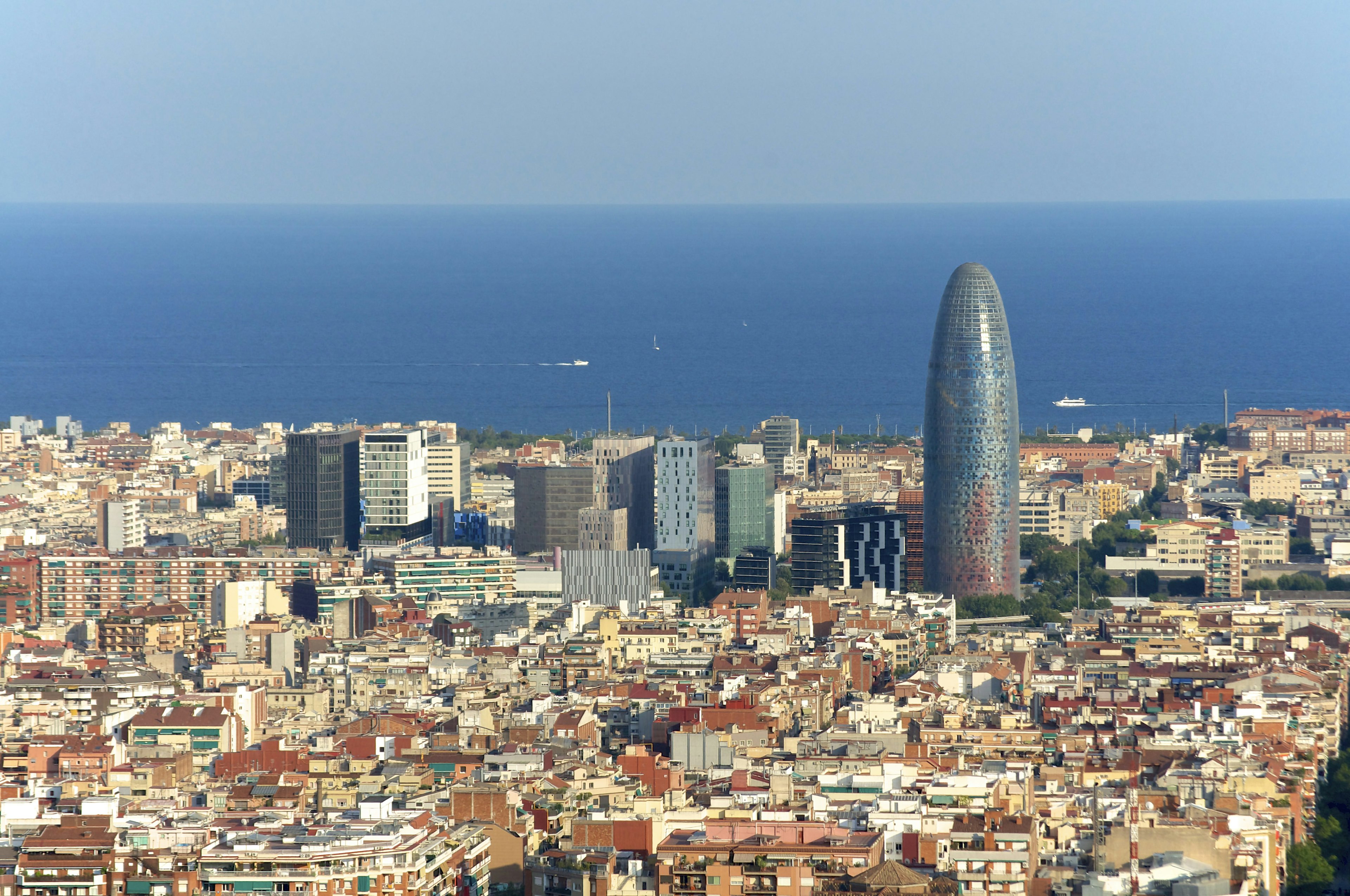 Looking over the skyline of Poblenou, with modern skyscrapers in the background and the blue Mediterranean beyond.