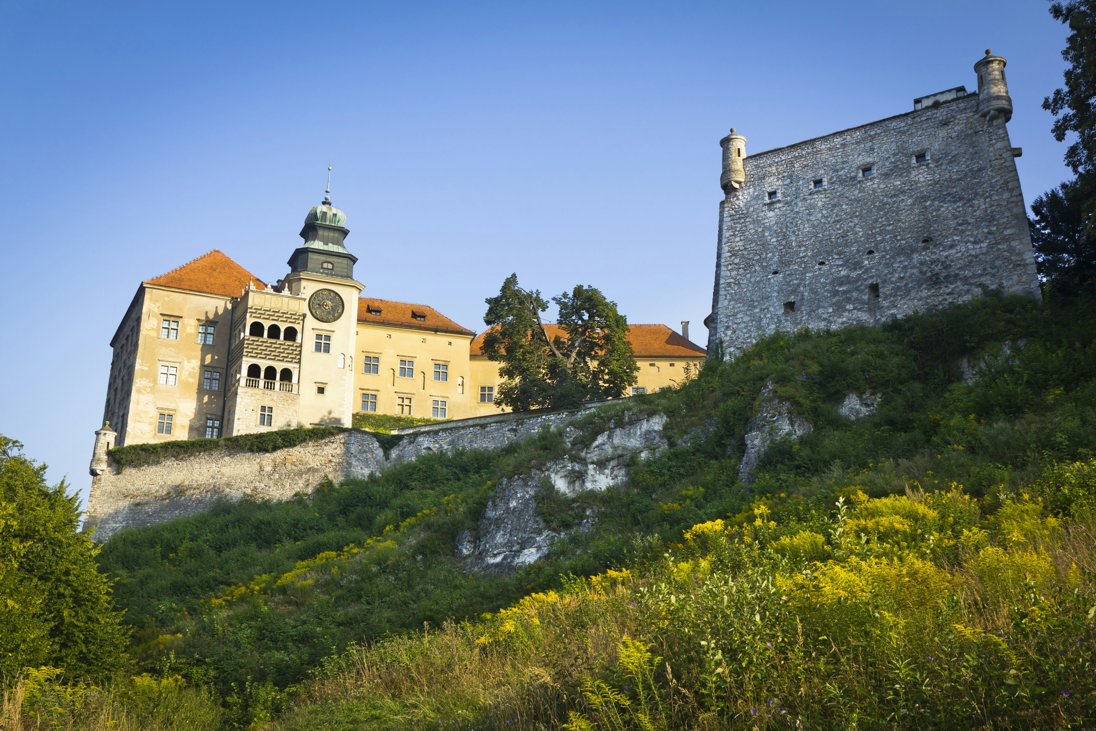 An upwards shot towards the battlements of a large castle with white stone walls