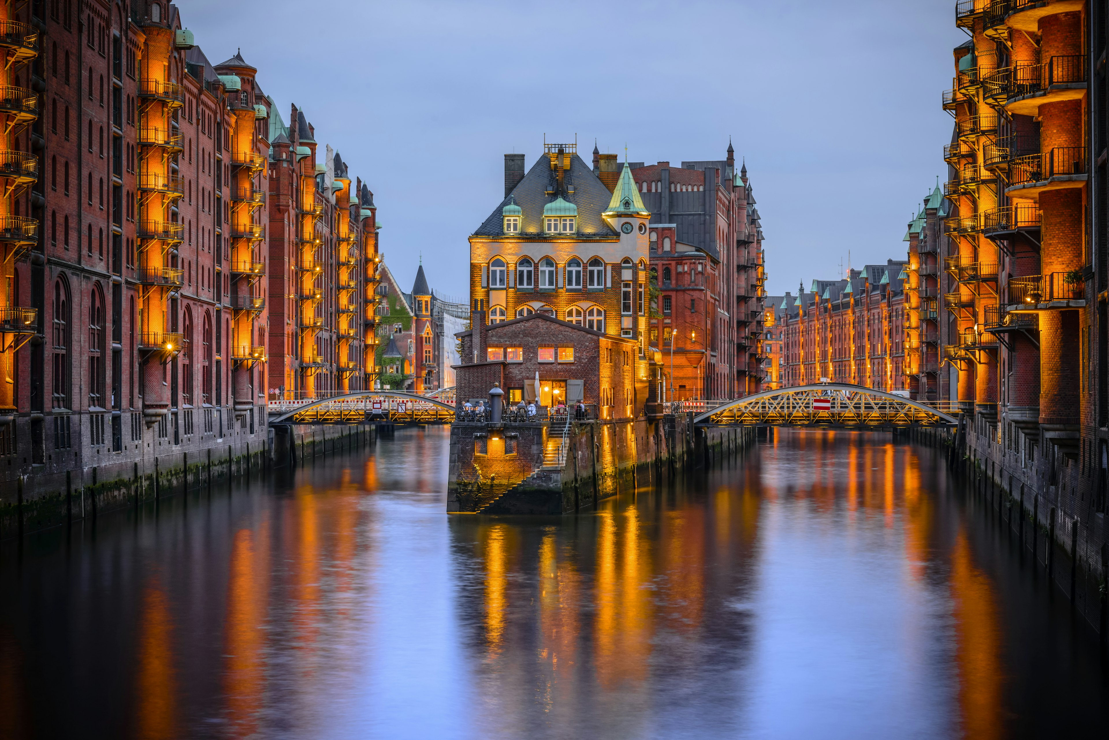 Hamburg city of warehouses at night with lights reflecting on the River Elbe