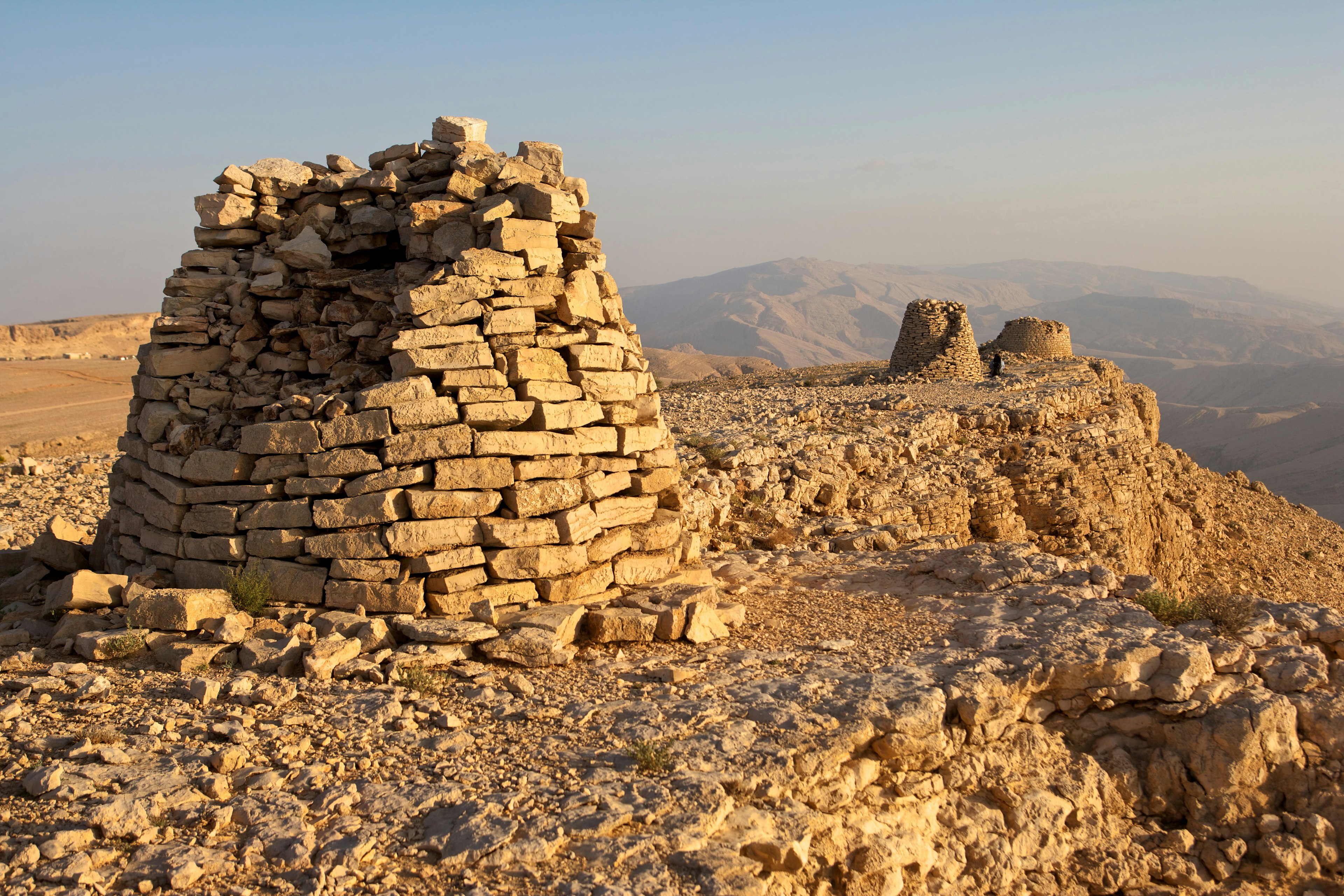 Lined up dramatically atop a rocky ridge, the Beehive Tombs of Bat, in Oman, are among the most unique ensemble of 4000-5000 year-old burial monuments, towers and remains of settlement in the Arabian Peninsula.