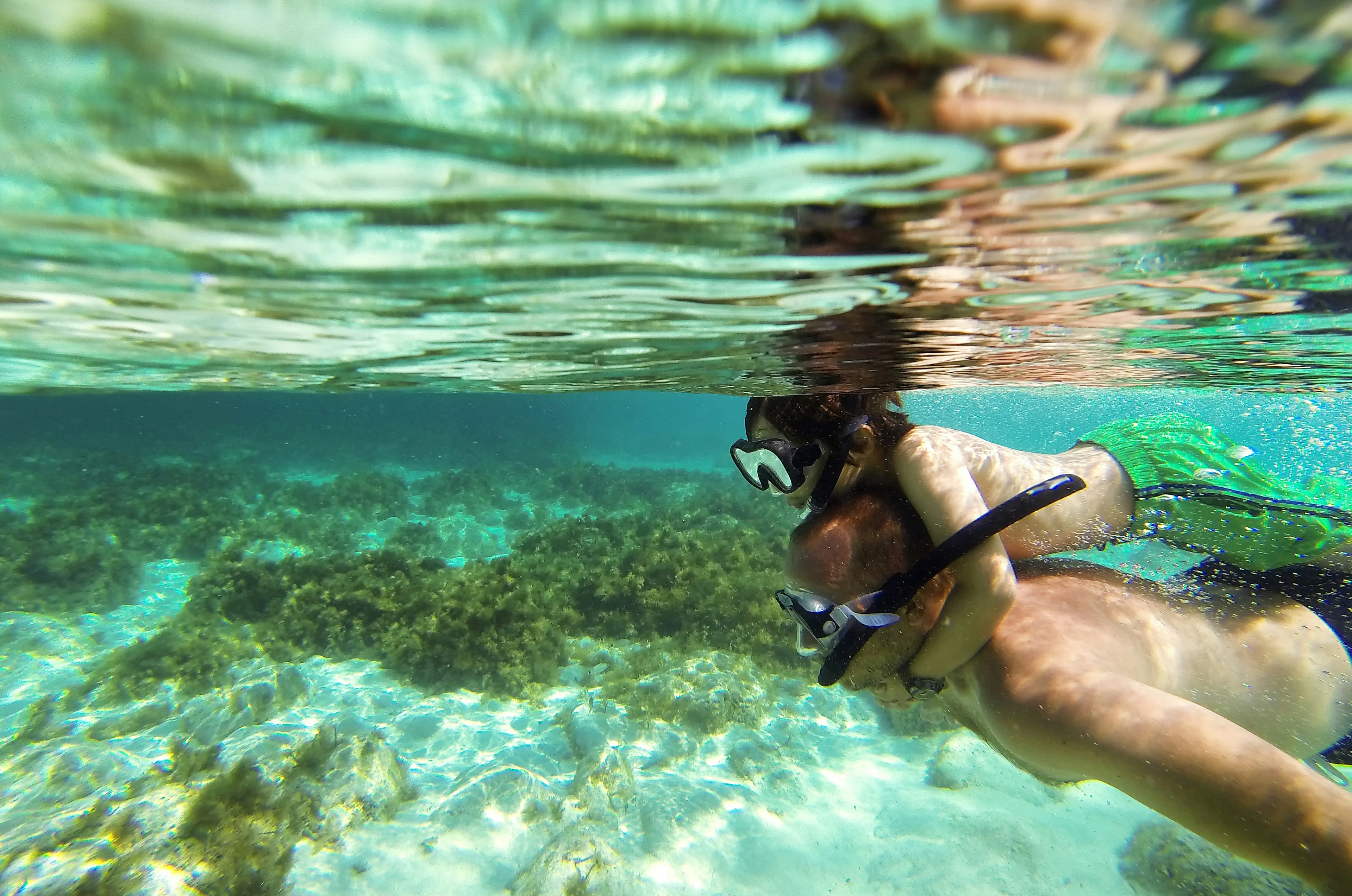 Father and son scuba diving in Malta