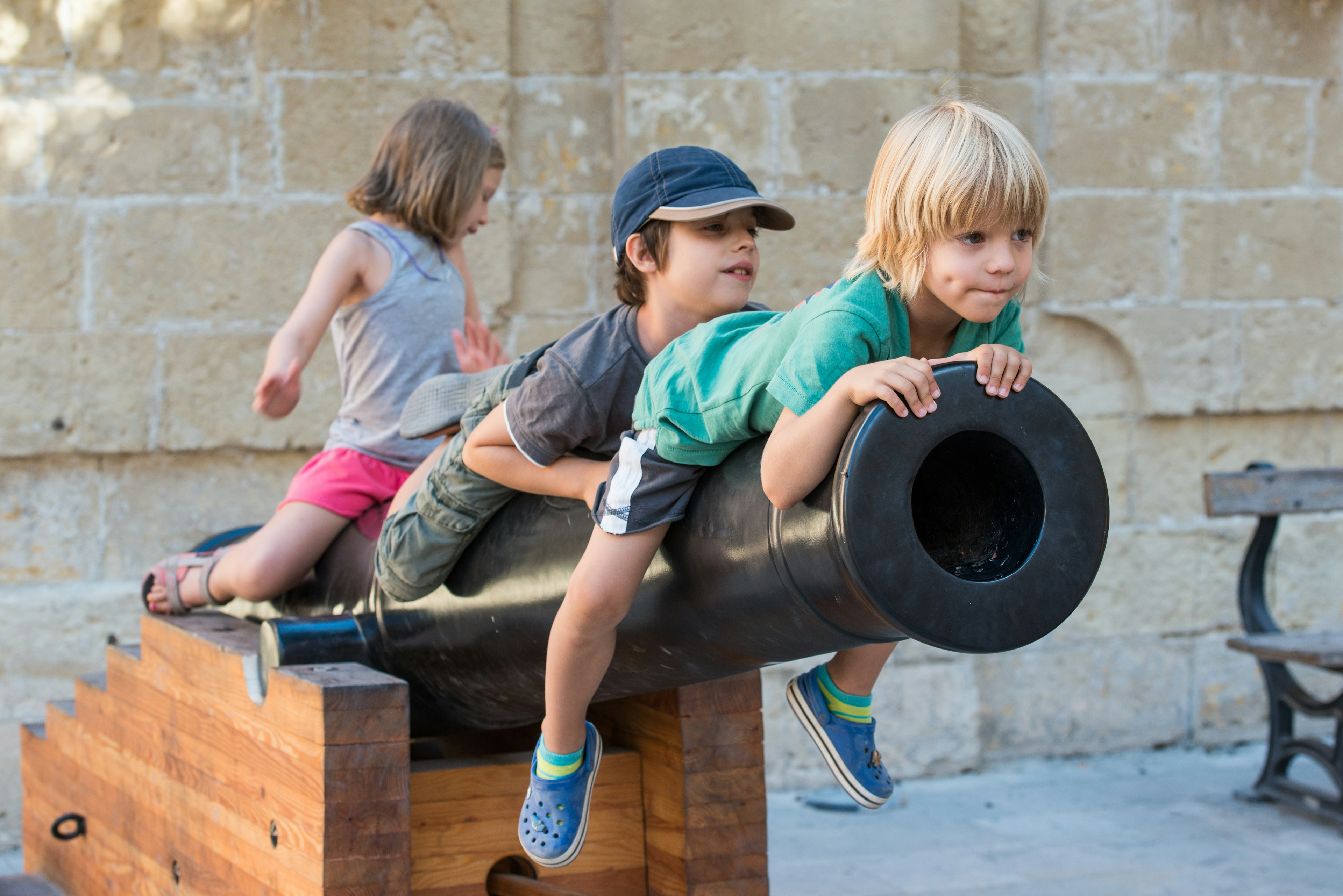 Children playing on a life sized cannon.