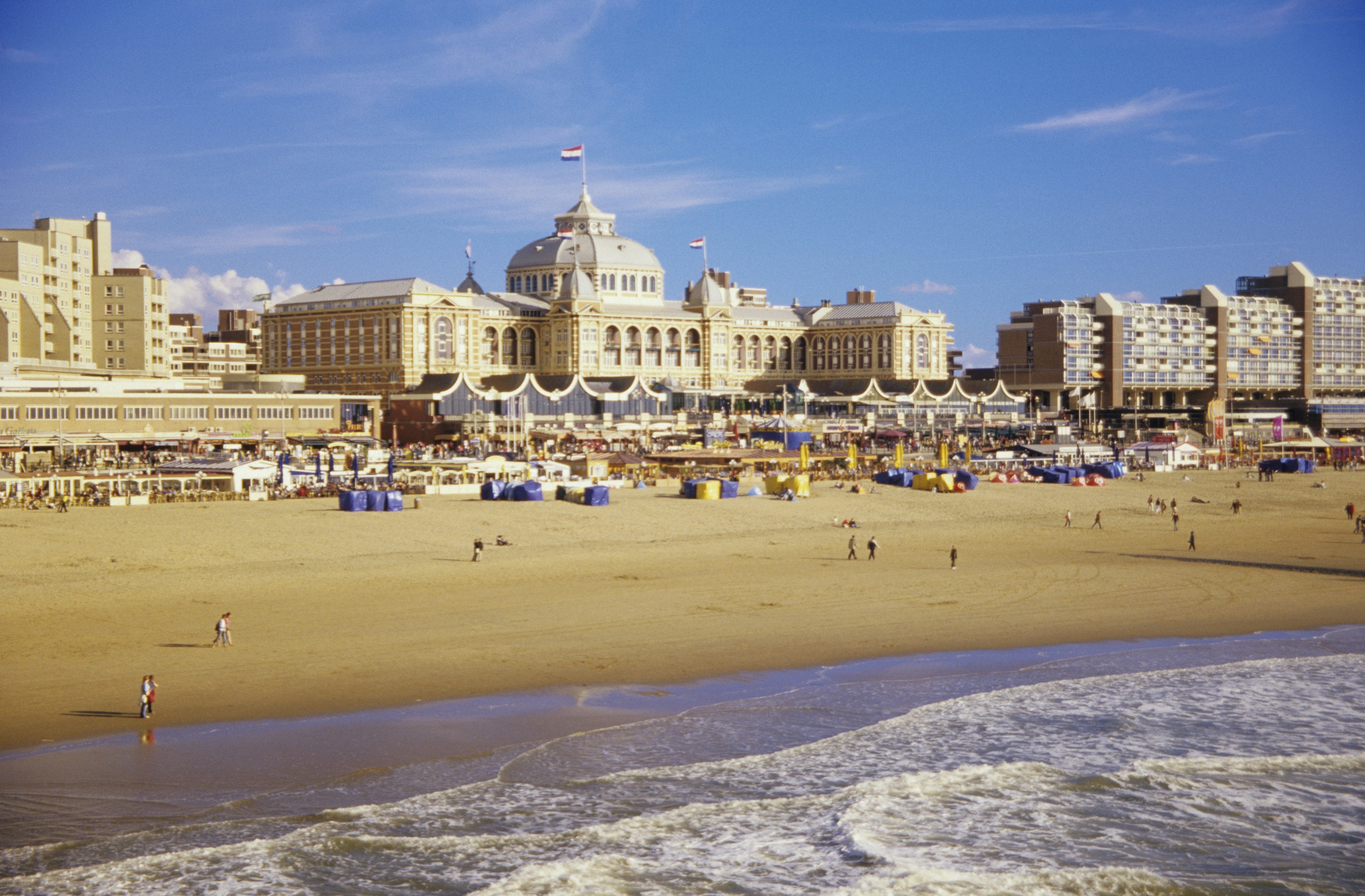 Beachgoers in front of the iconic Kurhaus on the sands of Scheveningen