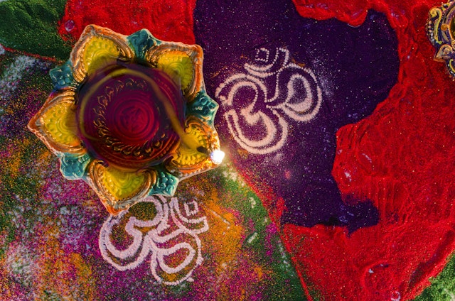 Diyas (oil lamps) and rangoli patterns made from colored powder are key features of Diwali. Puneet Vikram Singh/Getty Images