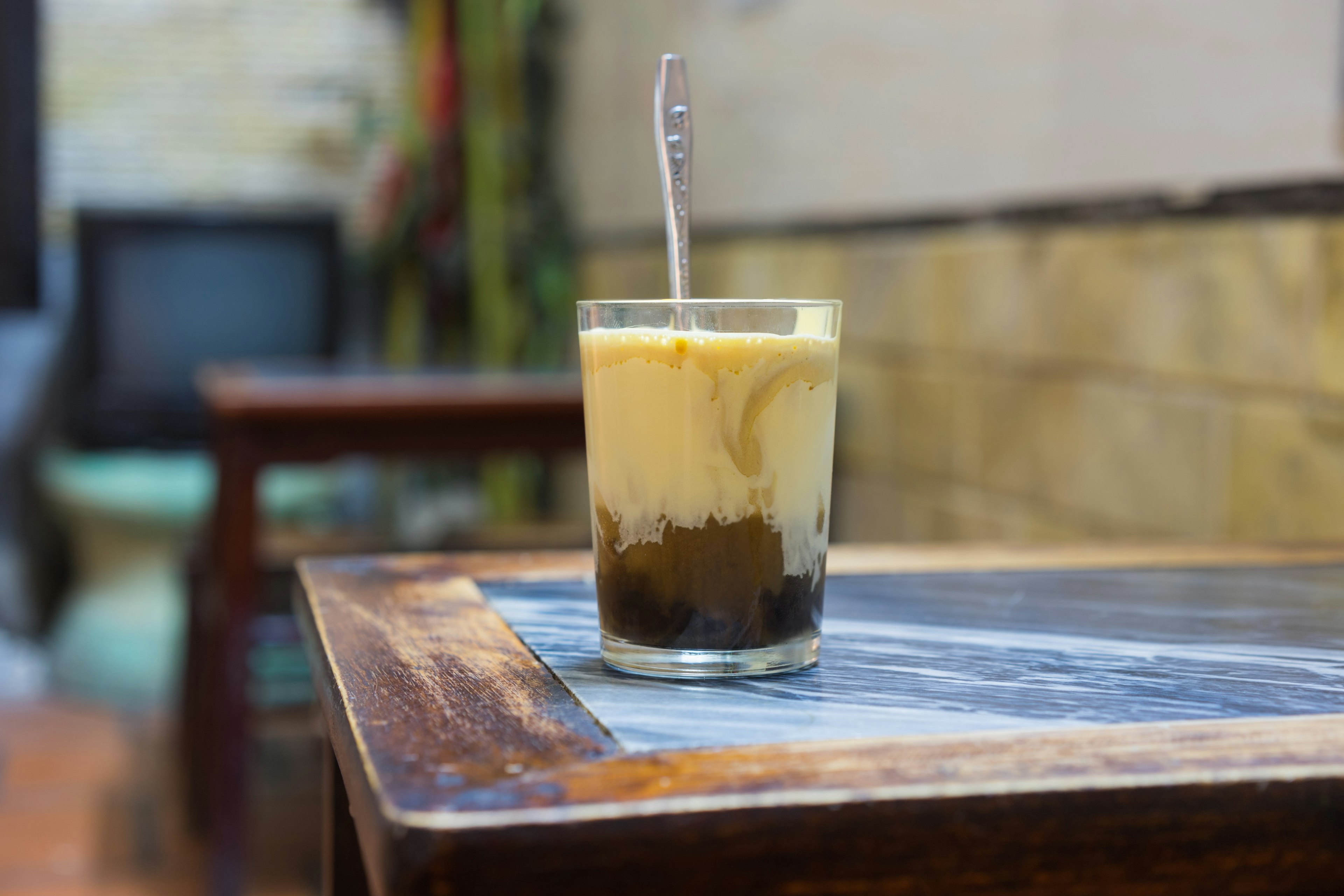 A cup of Giang egg coffee in Hanoi, found in 1946. The coffee is brewed in a small cup with a filter before the addition of a well-whisked mixture of the yolk and other ingredients.