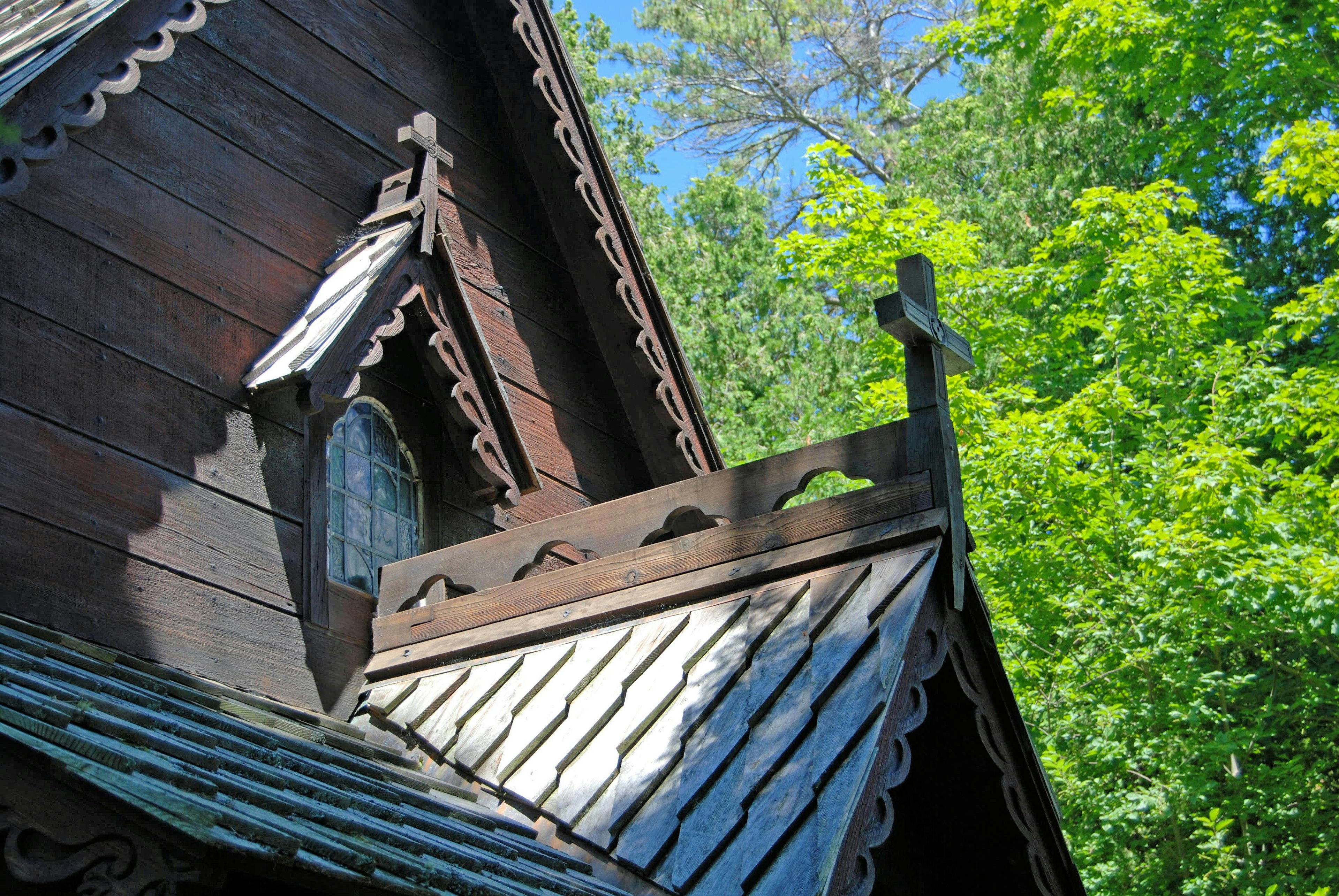 19th century wooden church, a weathered brown, with Scandinavian-style gingerbread trim in Door County