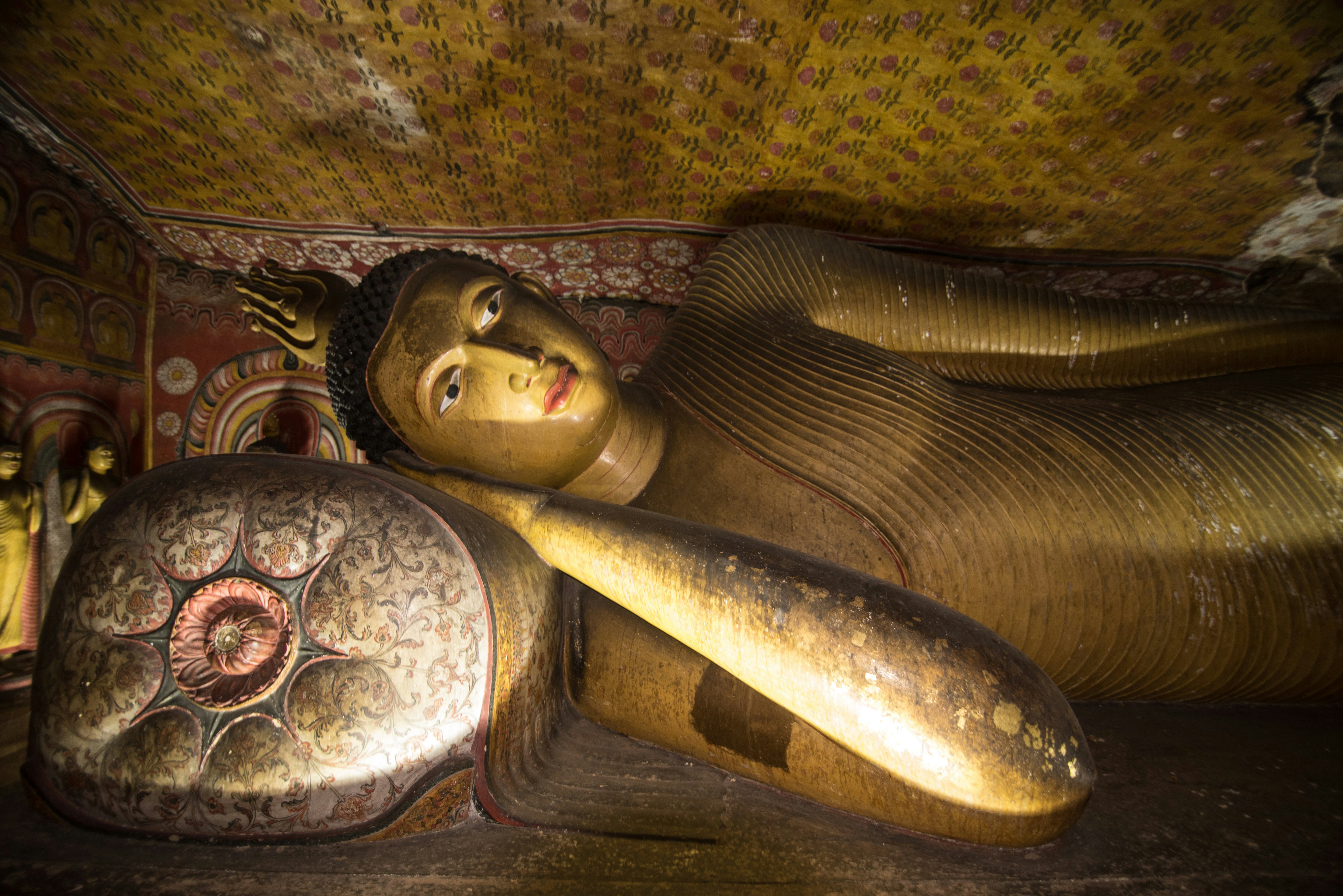 Reclining Buddha statue inside the Dambulla Royal Cave Temple..