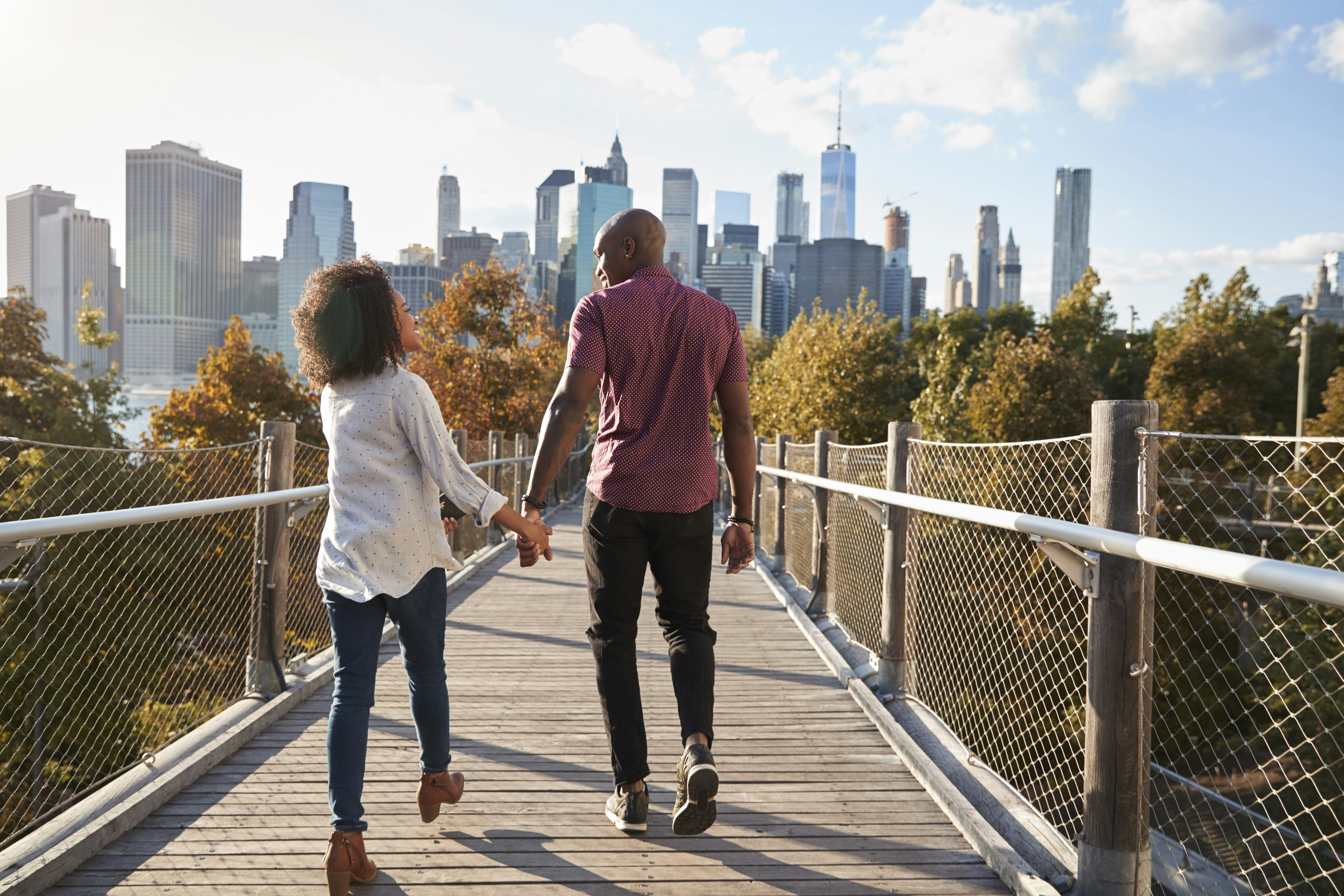 Couple walking with Manhattan skyline in the background