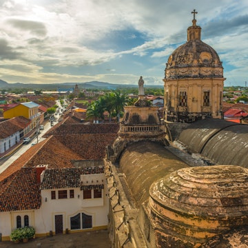 Skyline of Granada City at sunset with a view over the Merced church, Nicaragua, Central America.
928438734
Cathedral, Old, No People, Roof Tile, Latin America, Bell Tower - Tower, Cultures, History, Housing Problems, Sunlight, Dawn, Dusk, Capital Cities, Color Image, Travel Destinations, Horizontal, Outdoors, High Angle View, Catholicism, Religion, Granada - Nicaragua, Sky, Famous Place, Nicaragua, Church, Downtown District, Cityscape, Architecture, Building Exterior, Sunrise - Dawn, Sunset, Religious Cross, Cloud - Sky, House, City, Central America, Sun, Urban Skyline, City Street, Colors, Aerial View, Managua, Photography, UNESCO World Heritage Site, Street, Merced County, Len - Nicaragua, Tourism, Facade