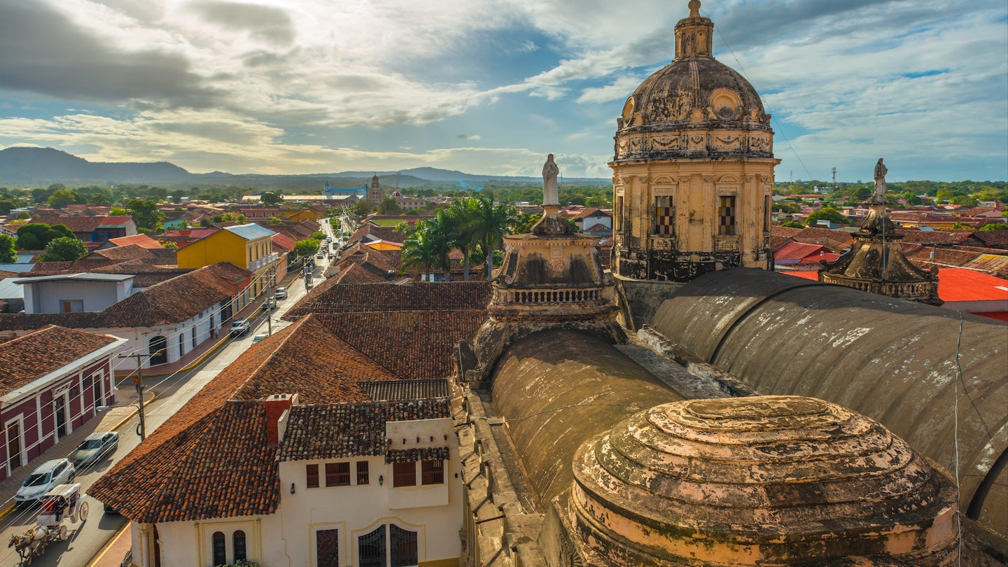 Skyline of Granada City at sunset with a view over the Merced church, Nicaragua, Central America.
928438734
Cathedral, Old, No People, Roof Tile, Latin America, Bell Tower - Tower, Cultures, History, Housing Problems, Sunlight, Dawn, Dusk, Capital Cities, Color Image, Travel Destinations, Horizontal, Outdoors, High Angle View, Catholicism, Religion, Granada - Nicaragua, Sky, Famous Place, Nicaragua, Church, Downtown District, Cityscape, Architecture, Building Exterior, Sunrise - Dawn, Sunset, Religious Cross, Cloud - Sky, House, City, Central America, Sun, Urban Skyline, City Street, Colors, Aerial View, Managua, Photography, UNESCO World Heritage Site, Street, Merced County, Len - Nicaragua, Tourism, Facade